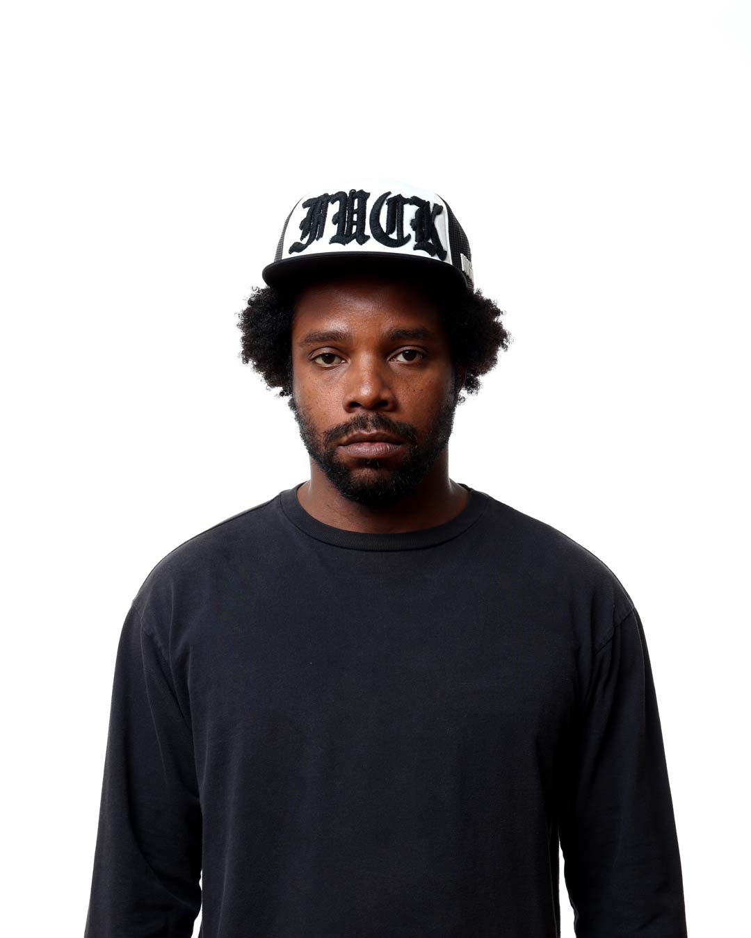 Man wearing a black cap with white text on a white background