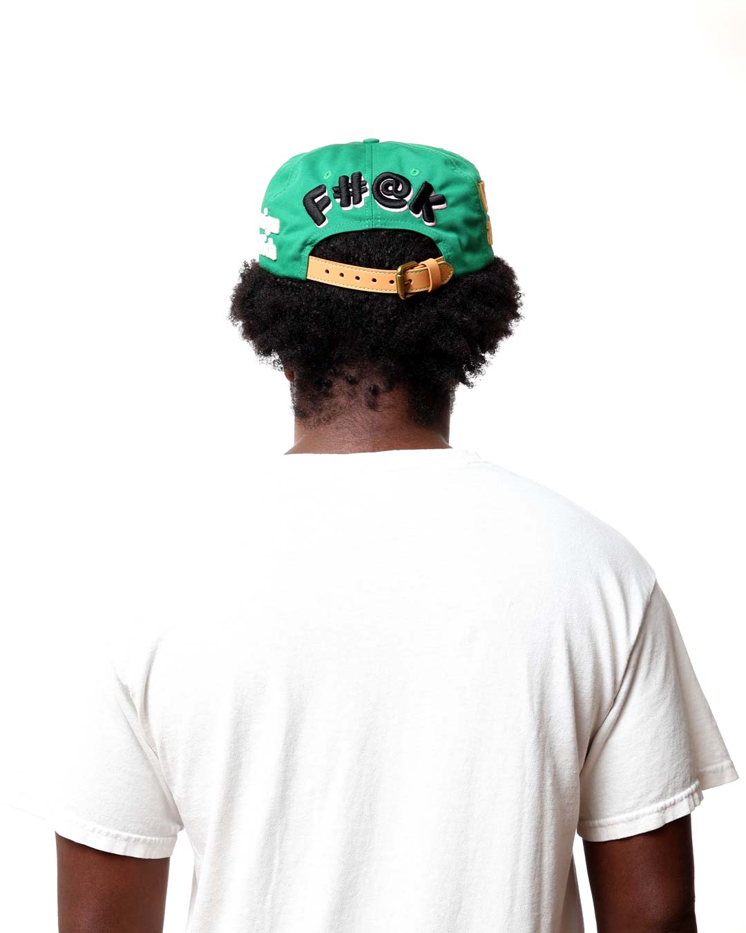 Person wearing a green cap with black text on a white background