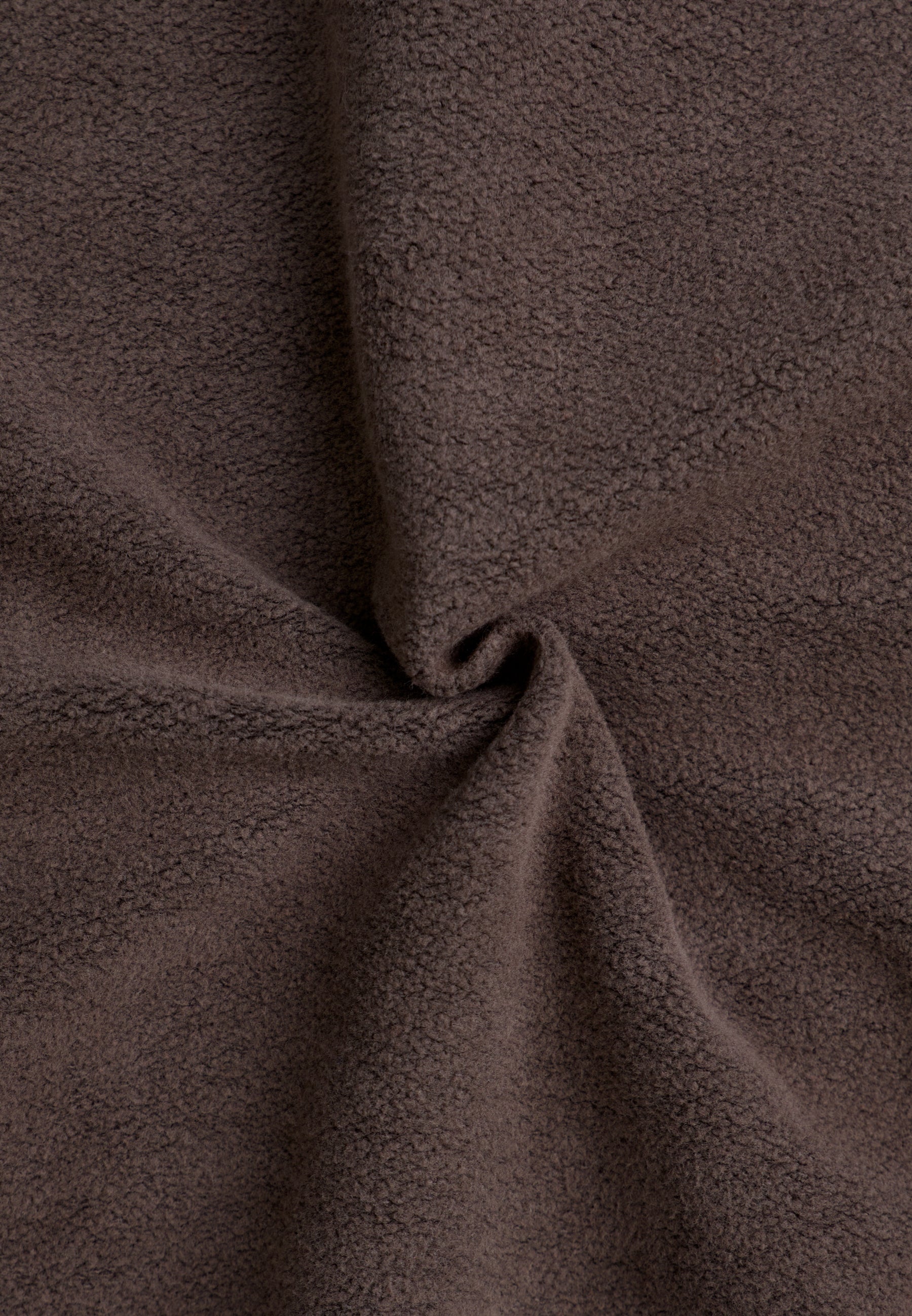 Brown textured fabric with spiral pattern.