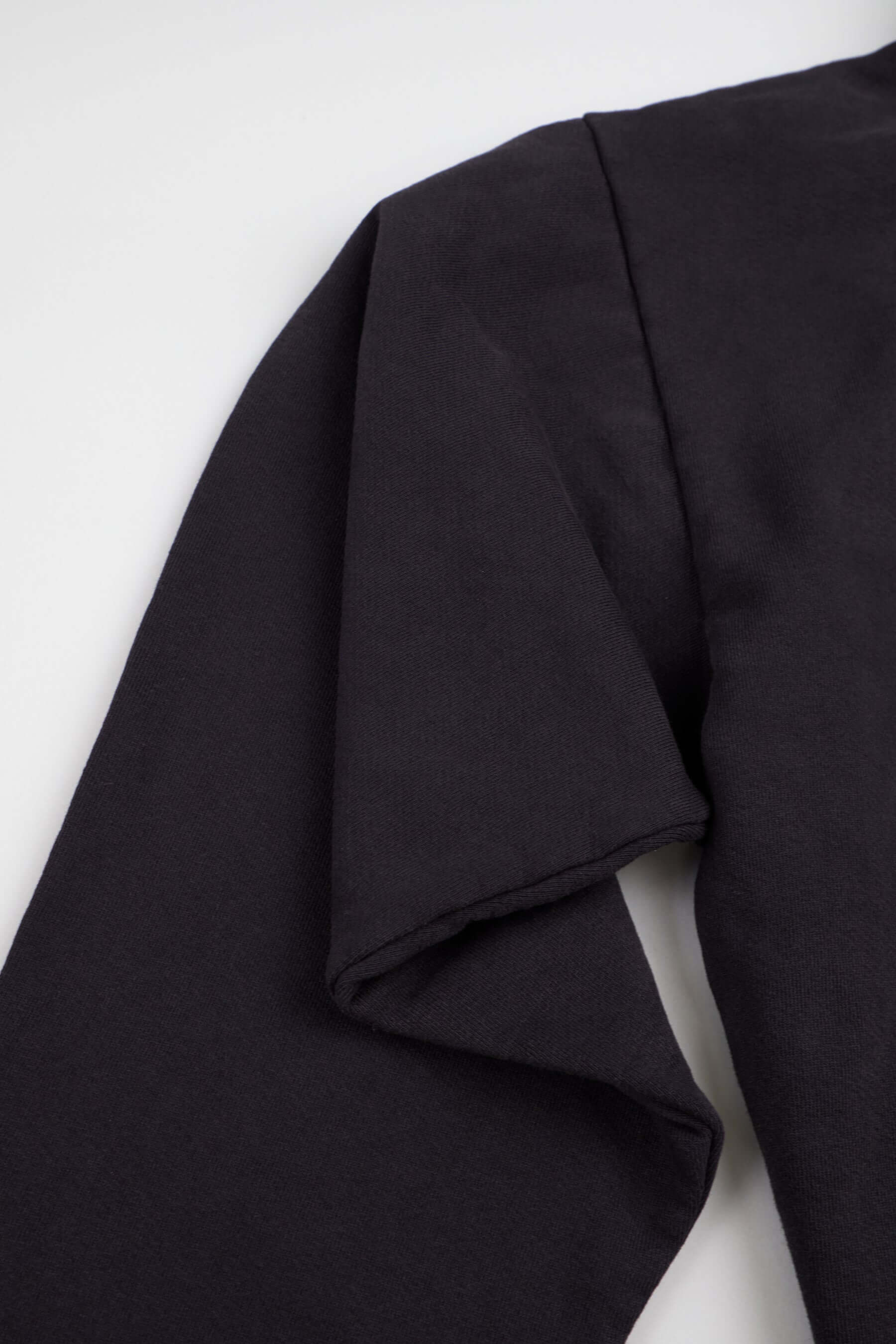 Black long-sleeve shirt on white background.