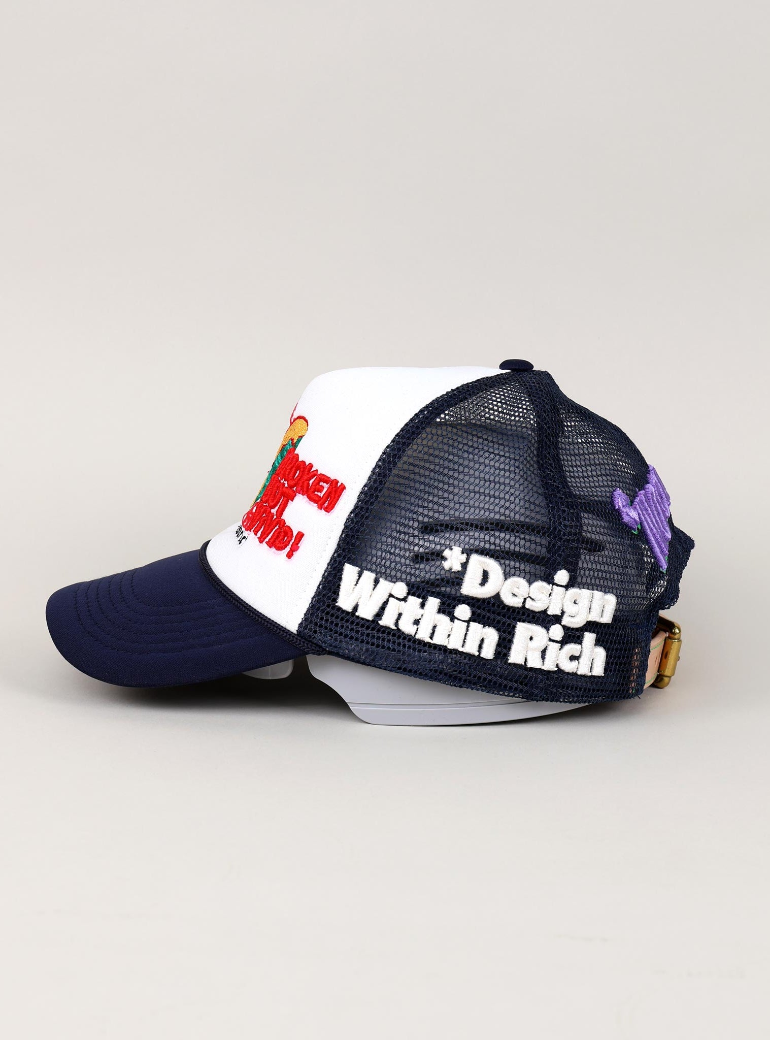 Navy and white trucker hat with embroidered text.