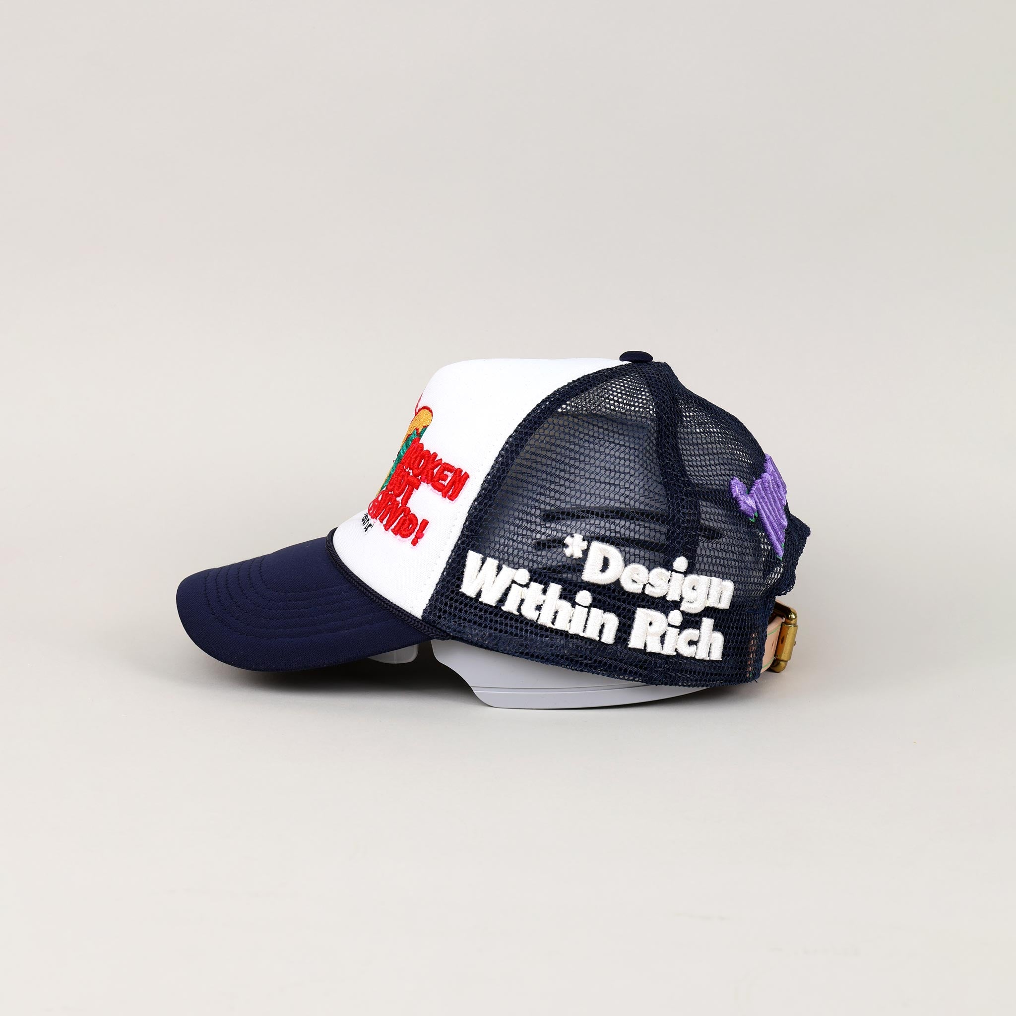 Navy and white trucker hat with embroidered text.