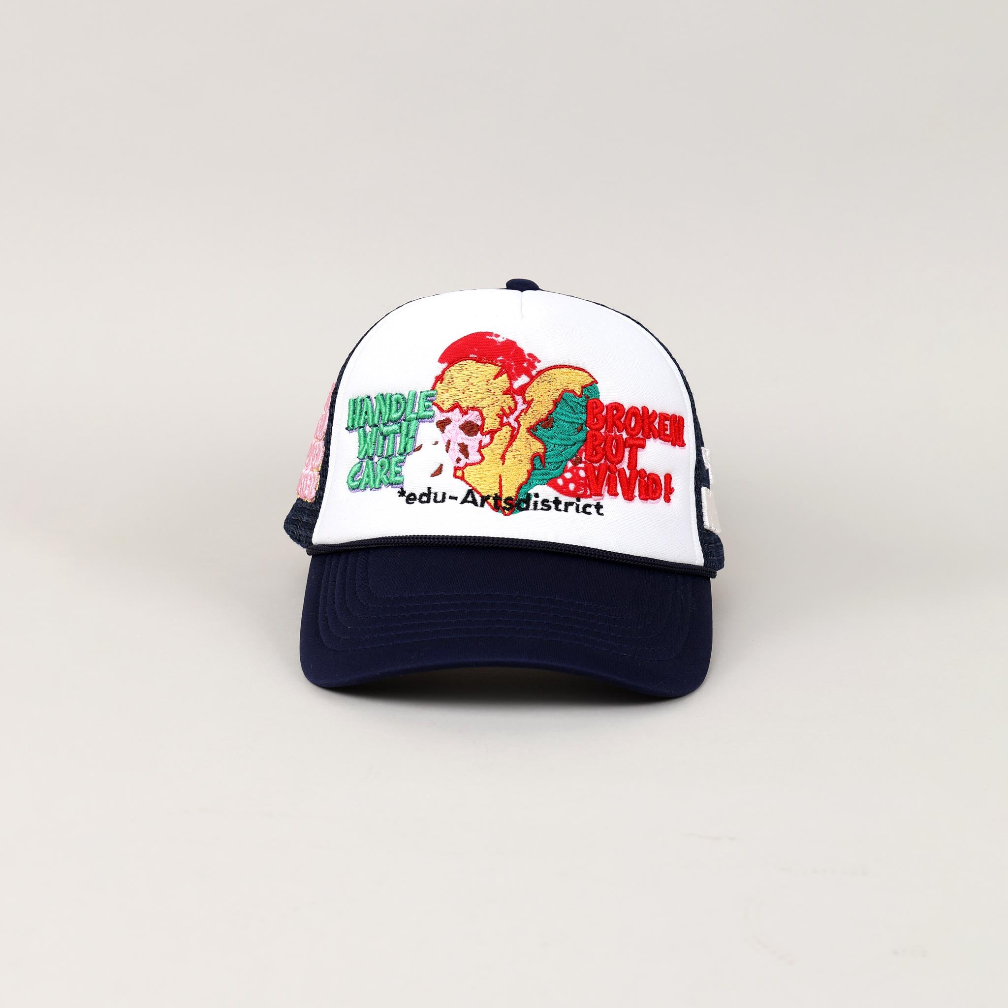 White and black cap with embroidered text and graphics.