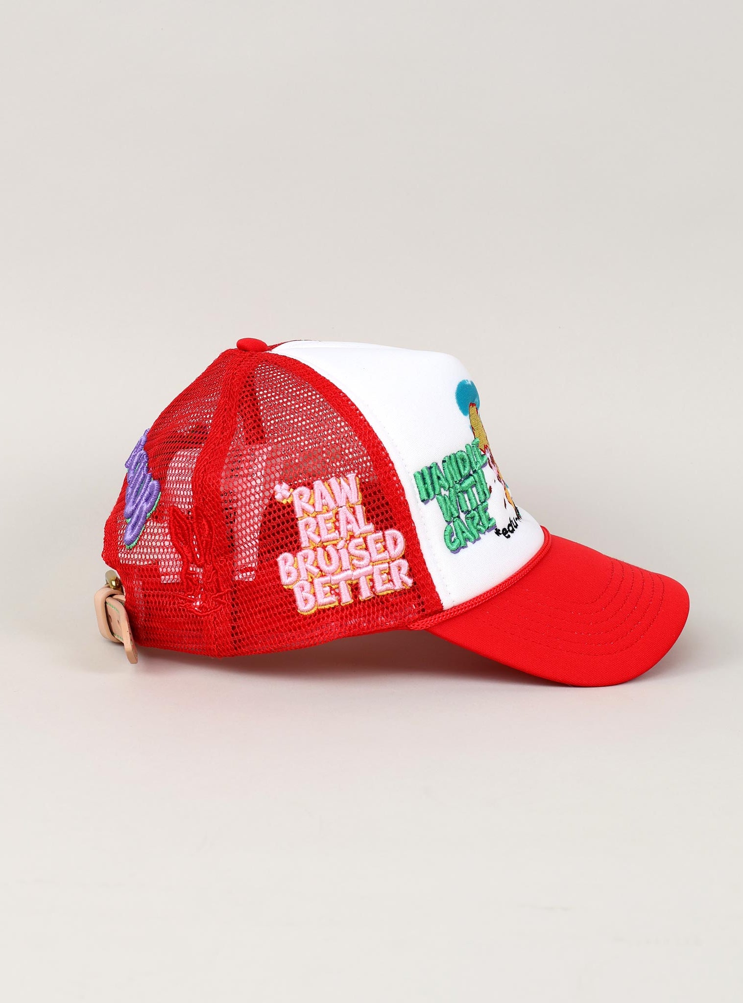 Red and white trucker hat with embroidered text.