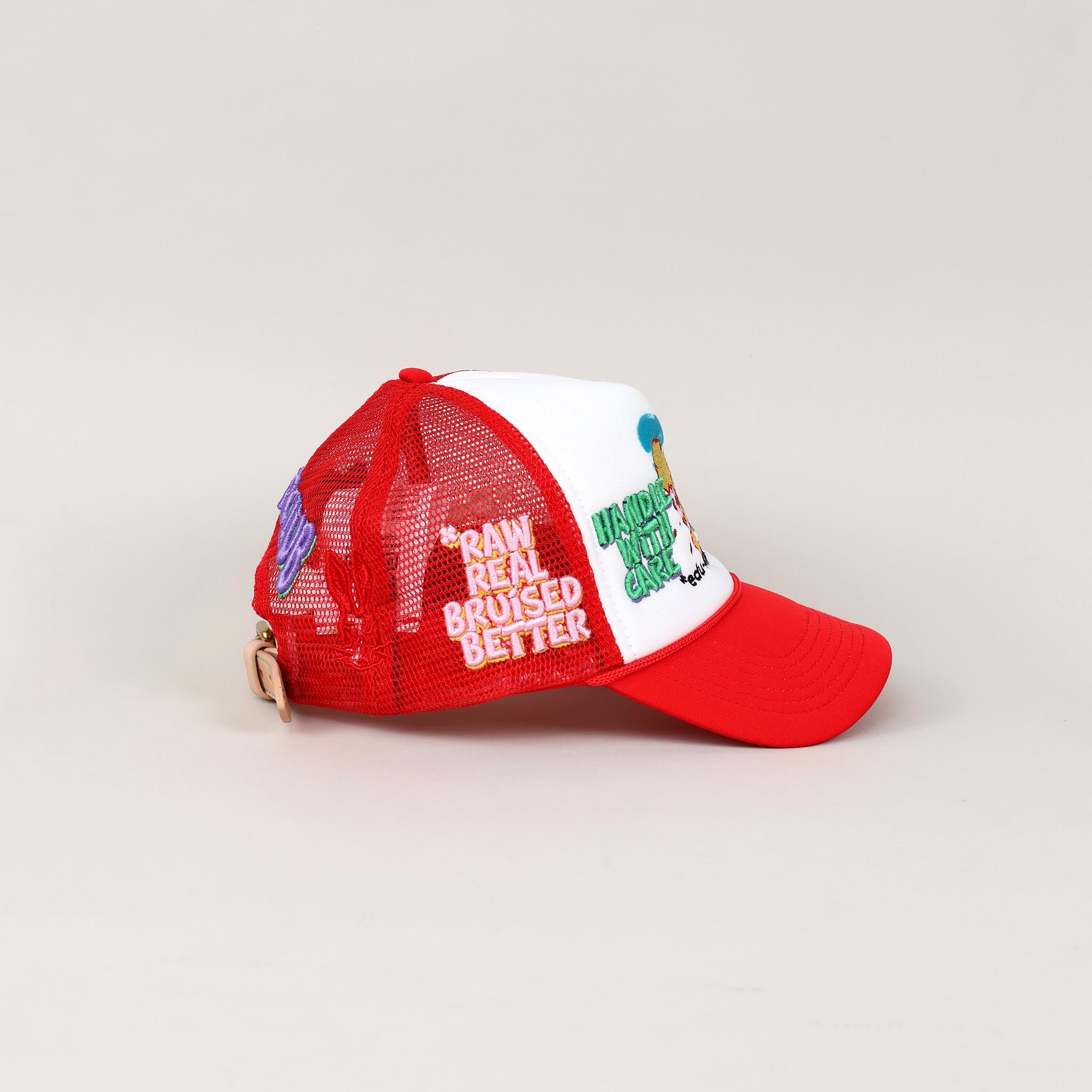 Red and white trucker hat with embroidered text.