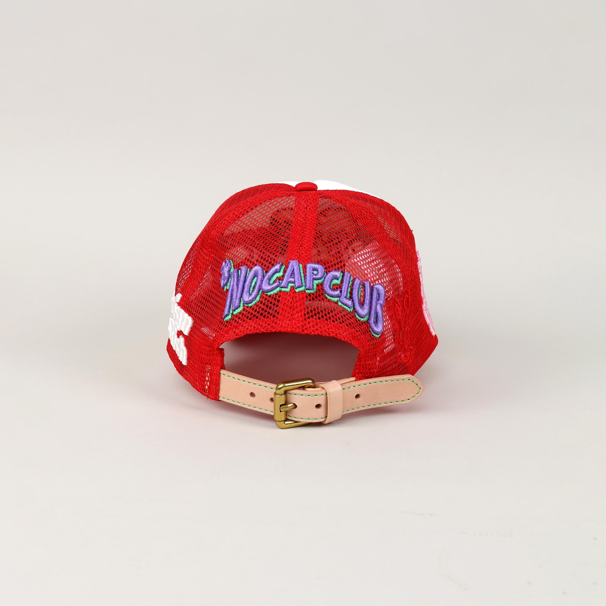 Red mesh cap with "NO CAP CLUB" embroidery.