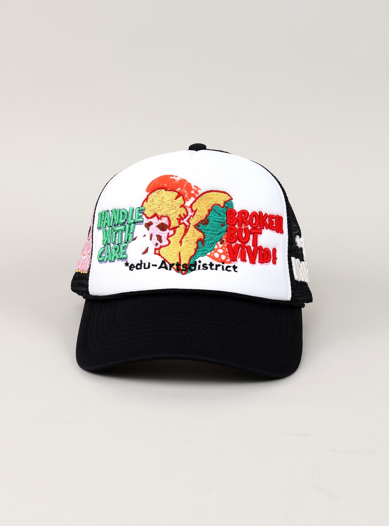 Black and white cap with embroidered text and graphics.