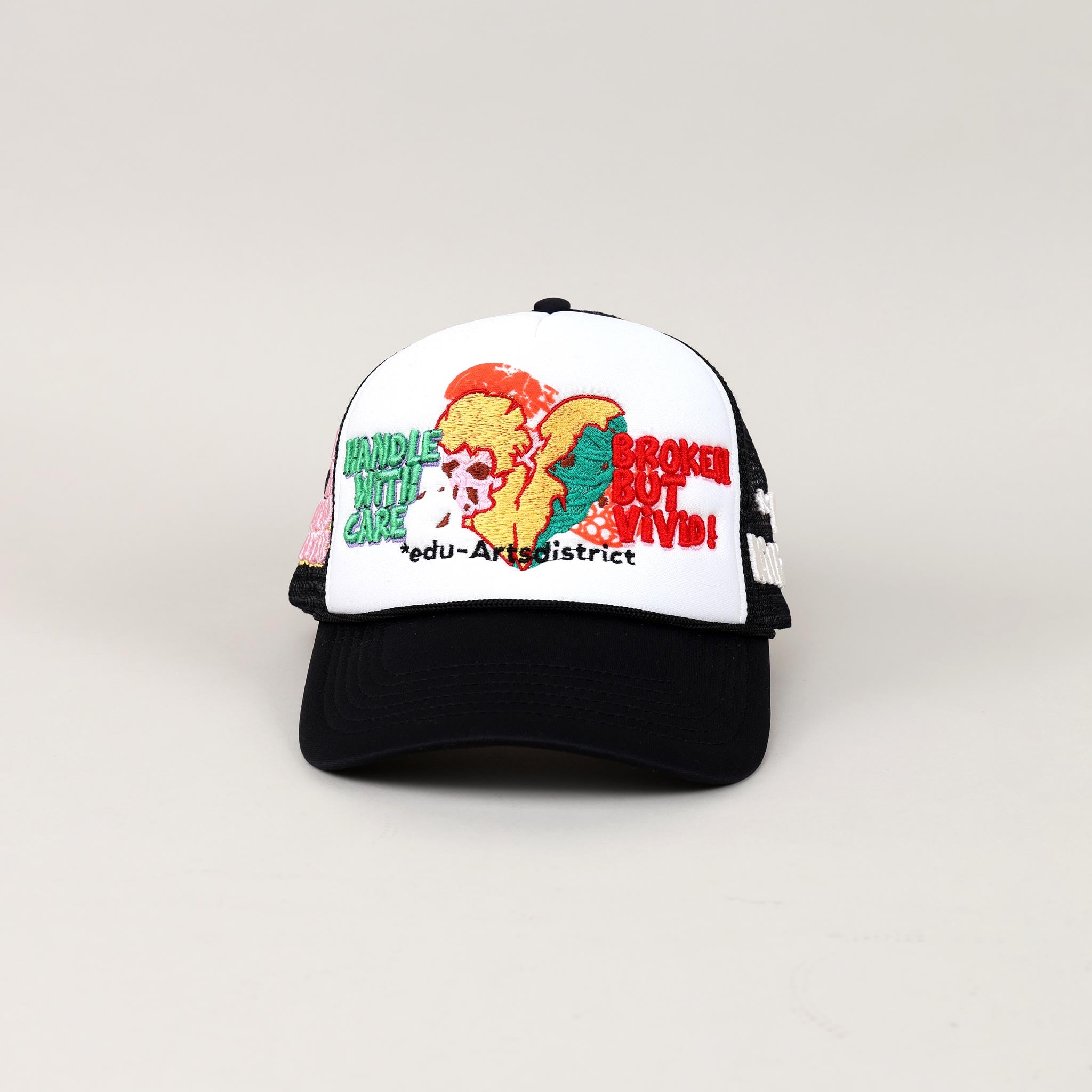 Black and white cap with embroidered text and graphics.