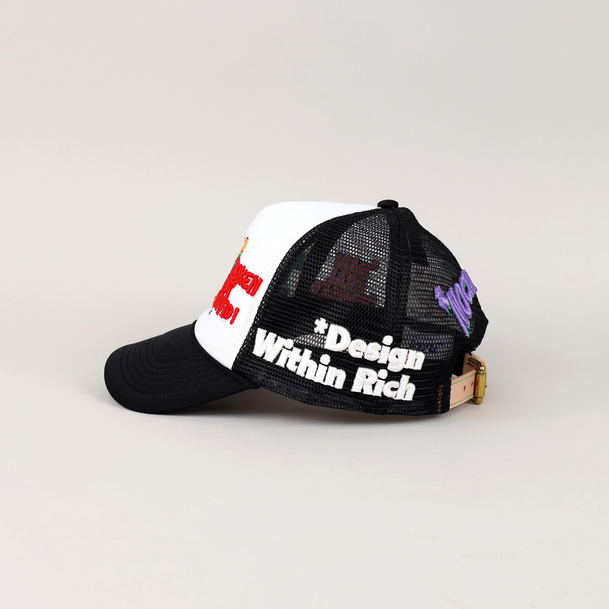 Black and white mesh cap with embroidered text.