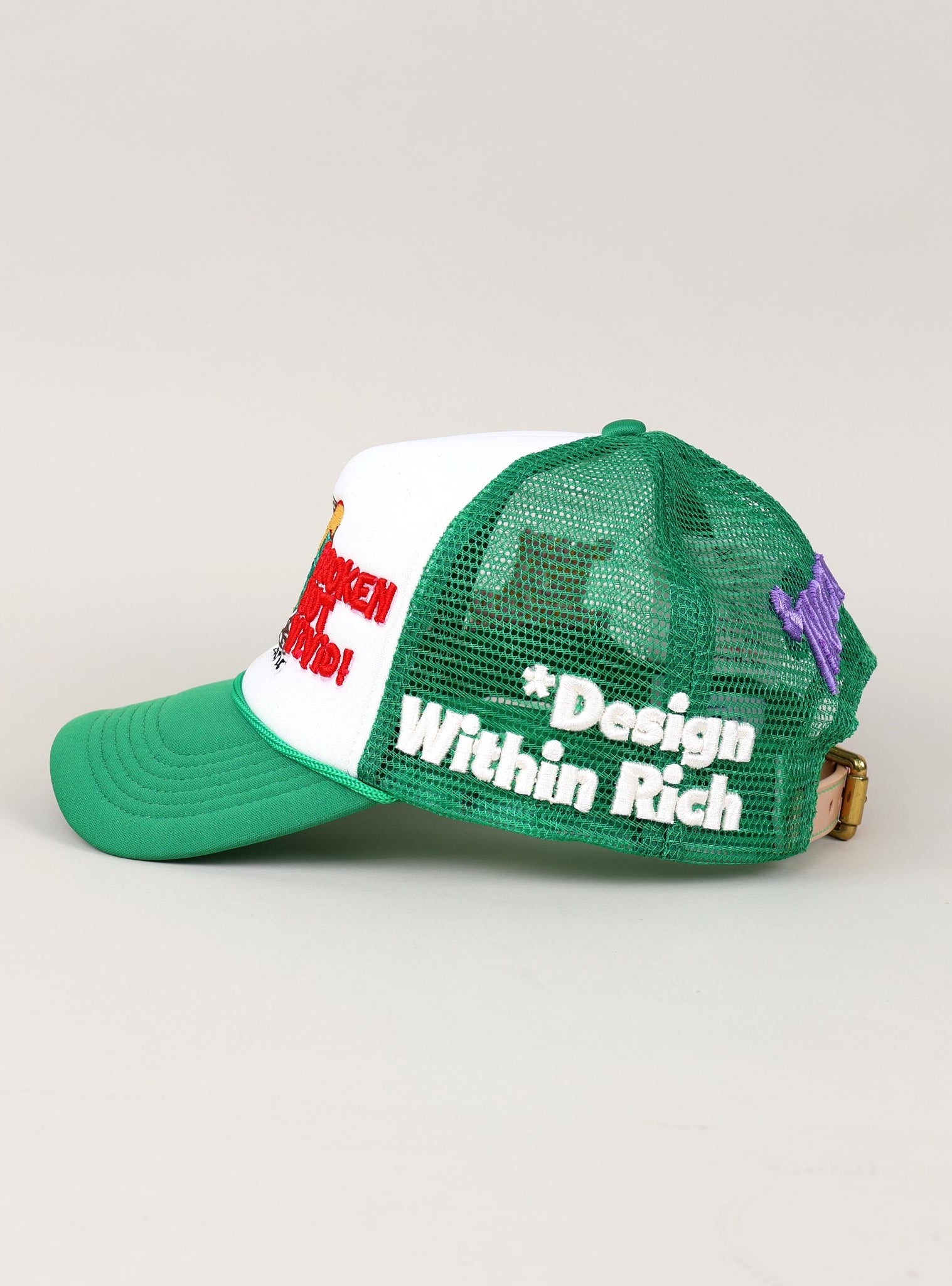 Green and white mesh cap with embroidered text.
