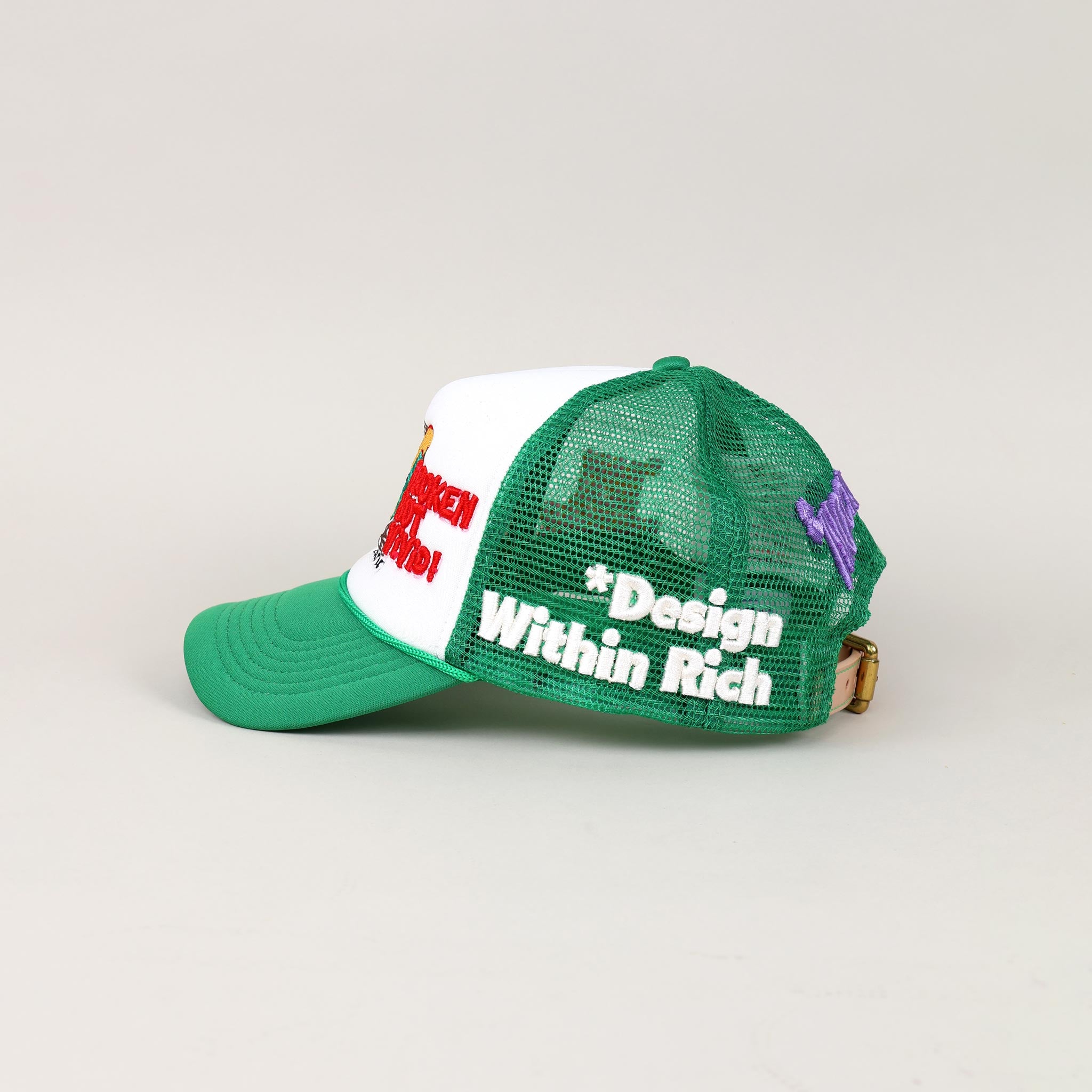Green and white mesh cap with embroidered text.