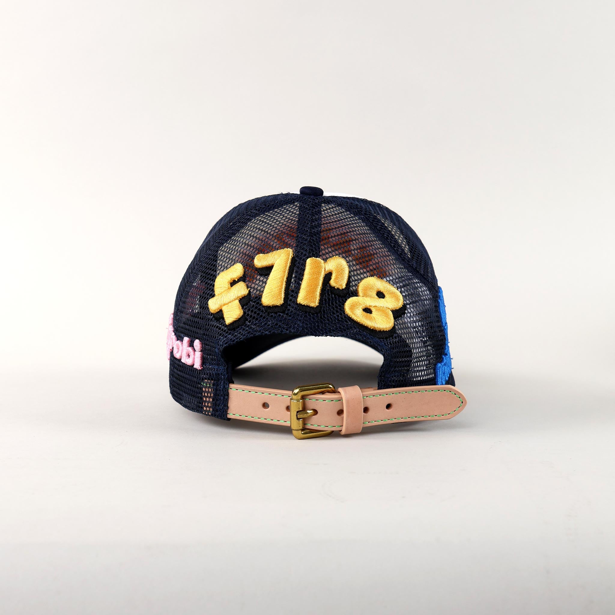 Back of a navy mesh cap with embroidery.