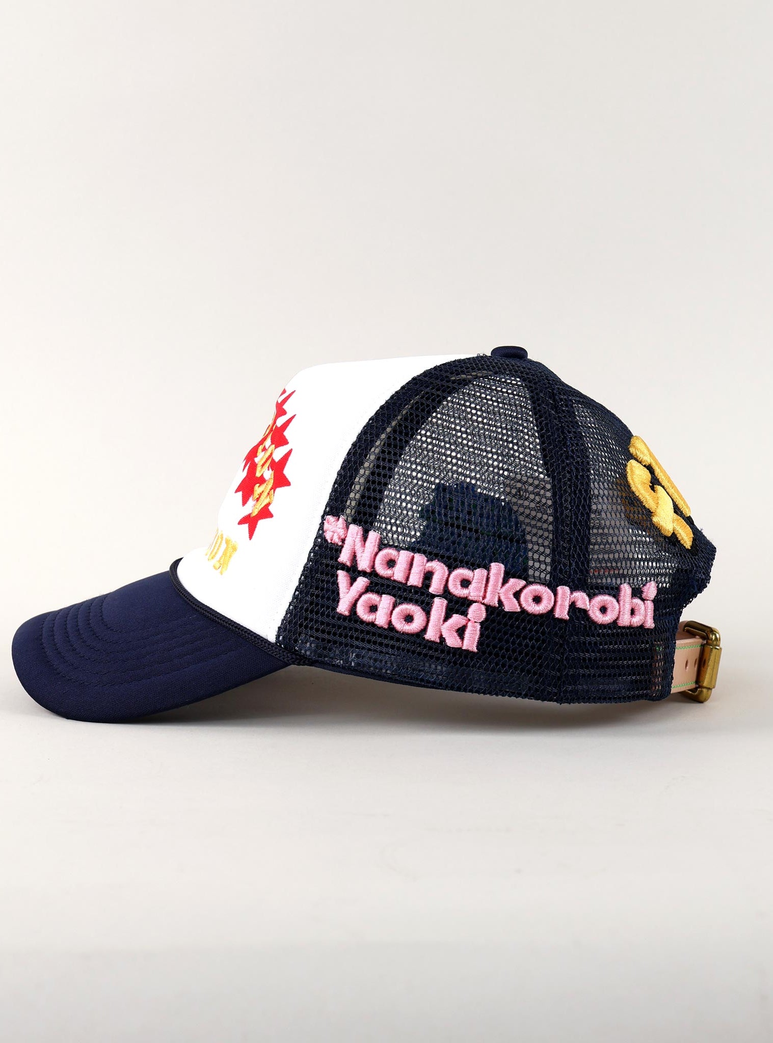 Trucker hat with embroidered text and designs.