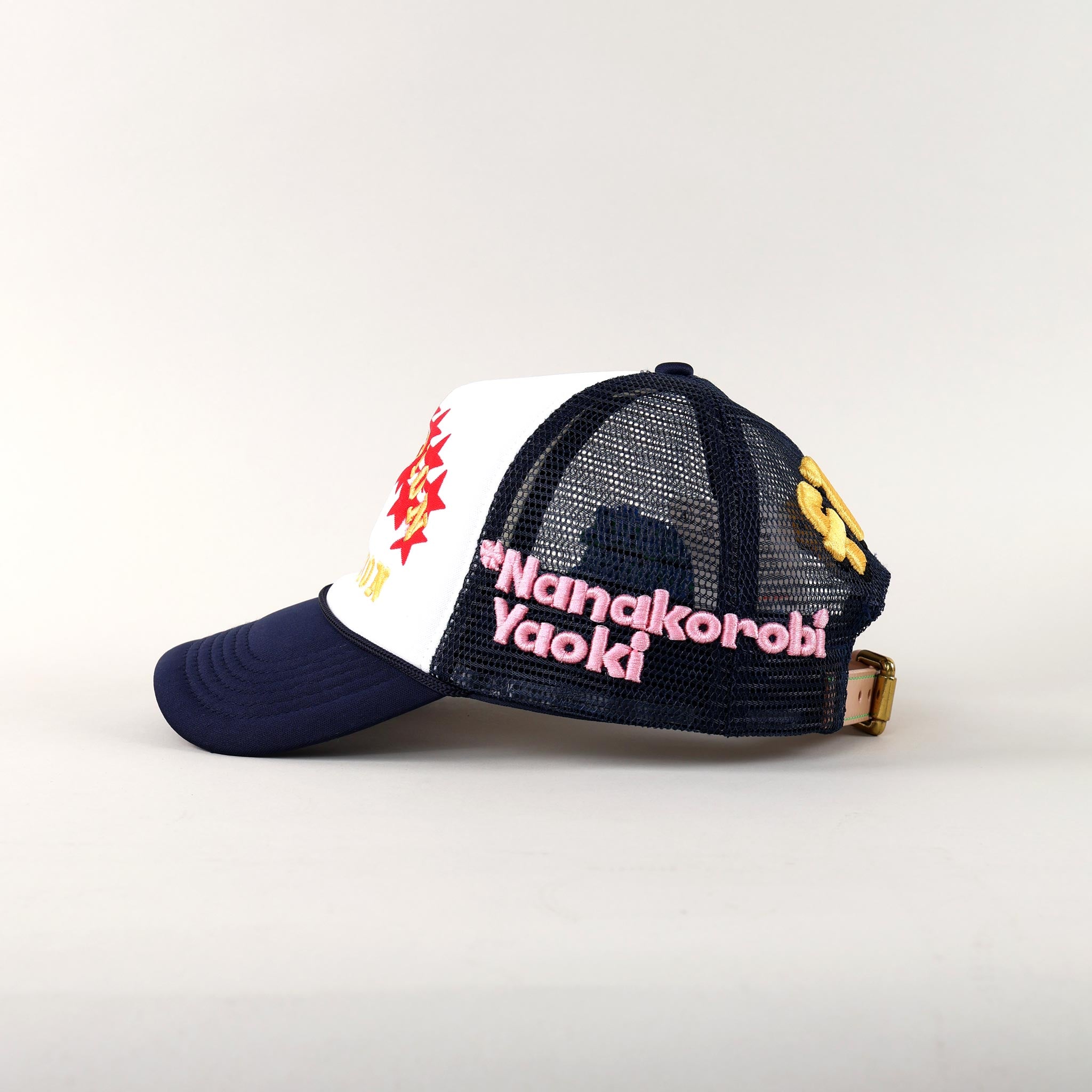 Trucker hat with embroidered text and designs.