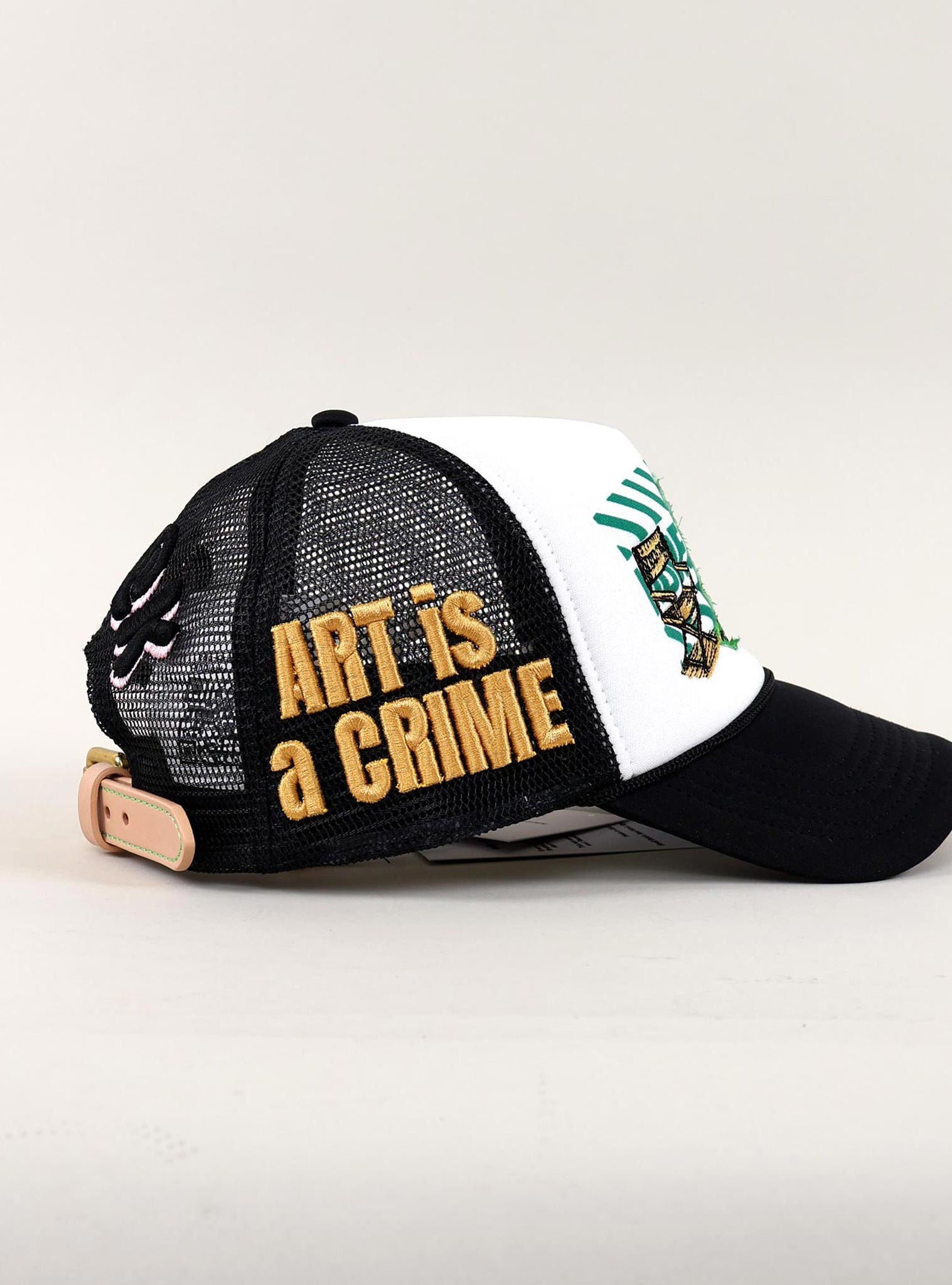 Black and white cap with "Art is a Crime."
