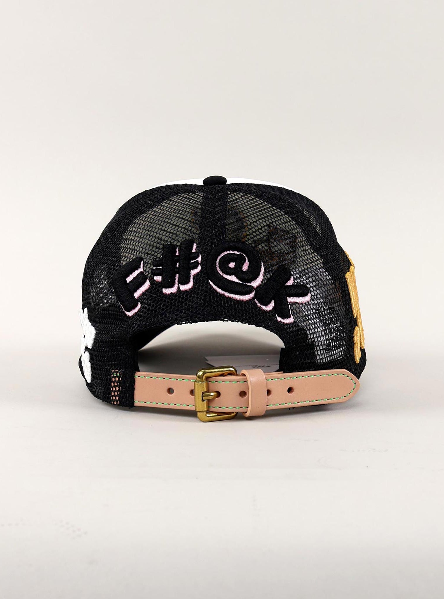 Back view of black mesh cap with embroidered text.