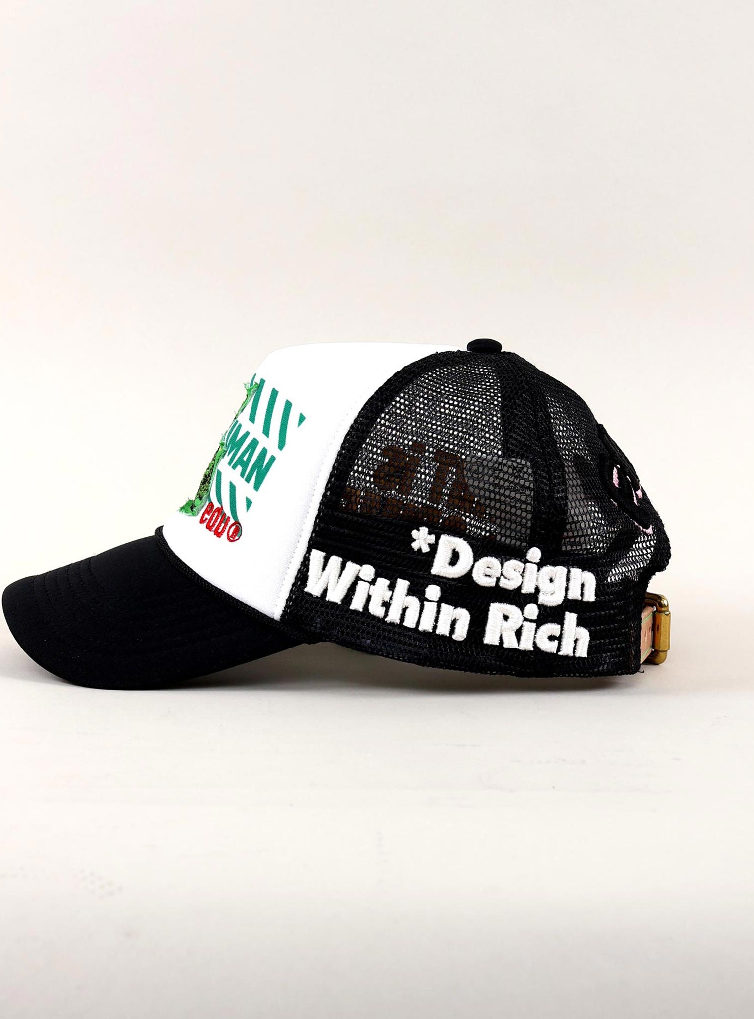 Black and white trucker hat with "Design Within Rich."