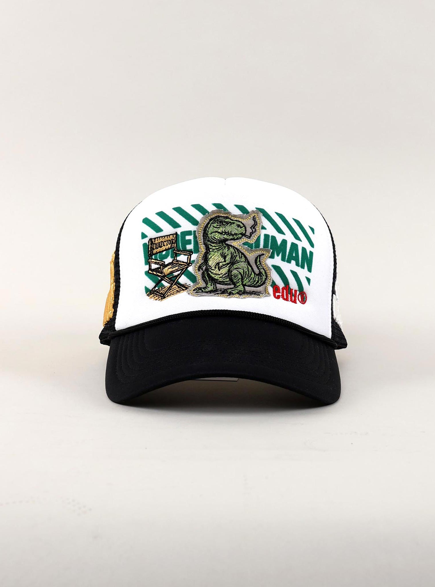 White and black cap with dinosaur and text design.