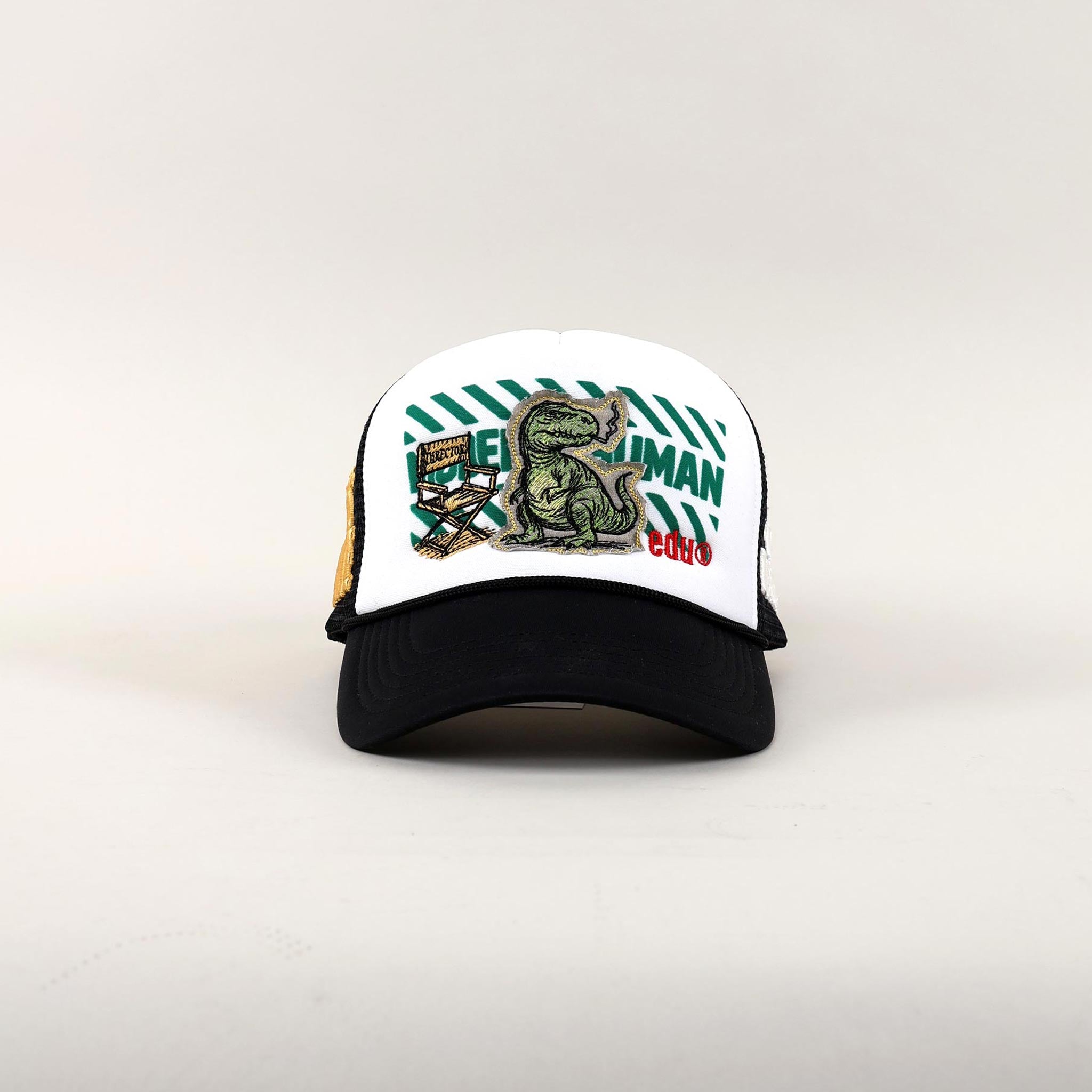 White and black cap with dinosaur and text design.