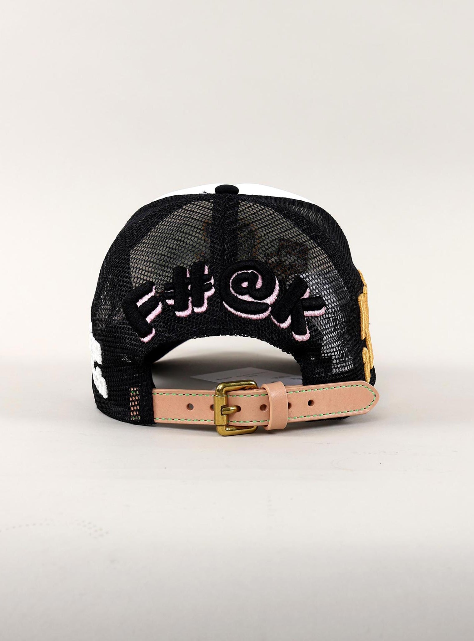 Back view of black mesh cap with embroidered text.