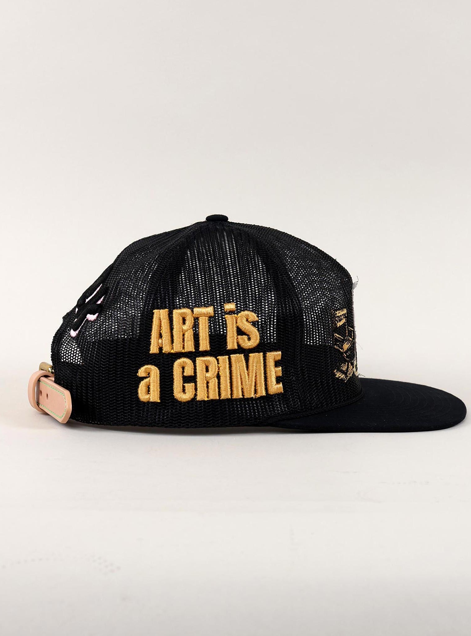 Black and white cap with "Art is a Crime."