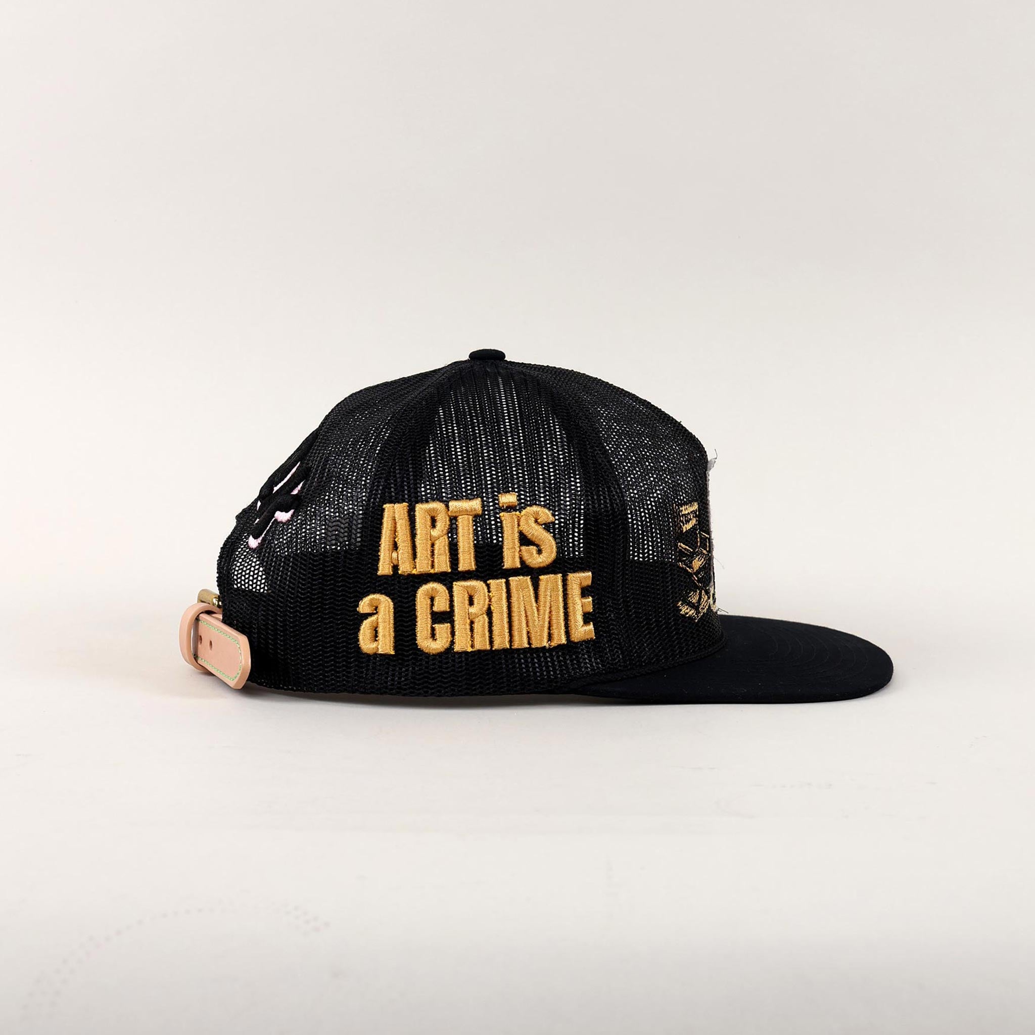 Black and white cap with "Art is a Crime."