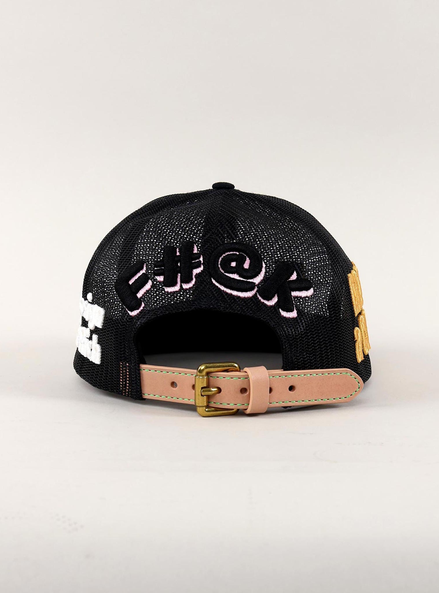 Back view of black mesh cap with embroidered text.