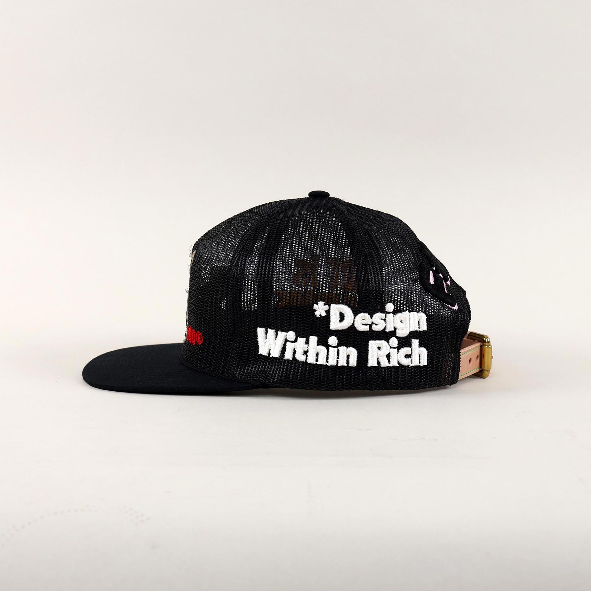 Black and white trucker hat with "Design Within Rich."