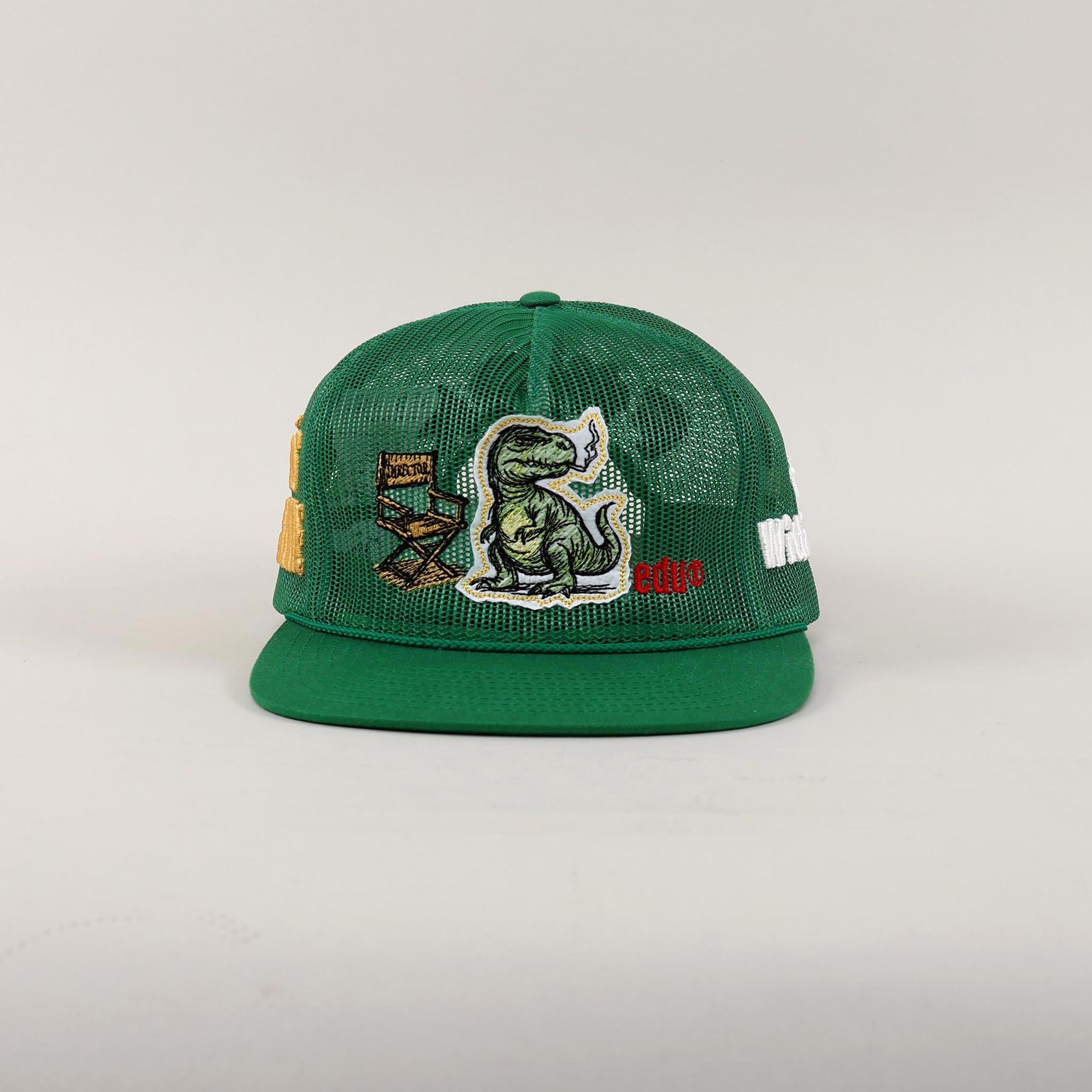 Green mesh cap with dinosaur and chair patches.