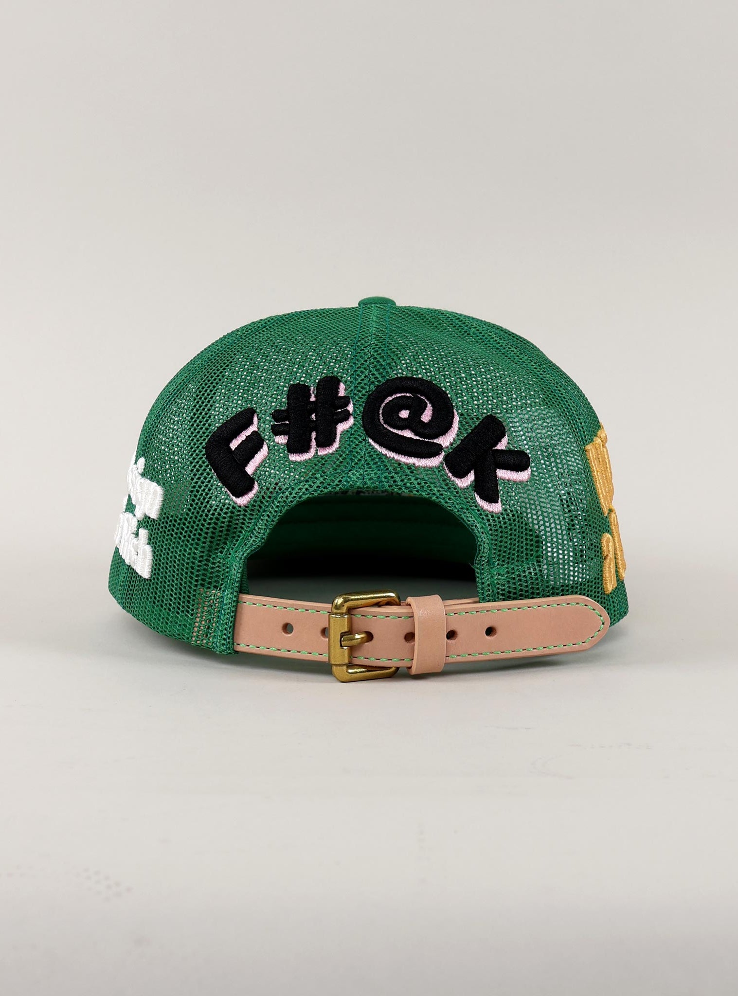 Black mesh cap with embroidered text and tan strap.