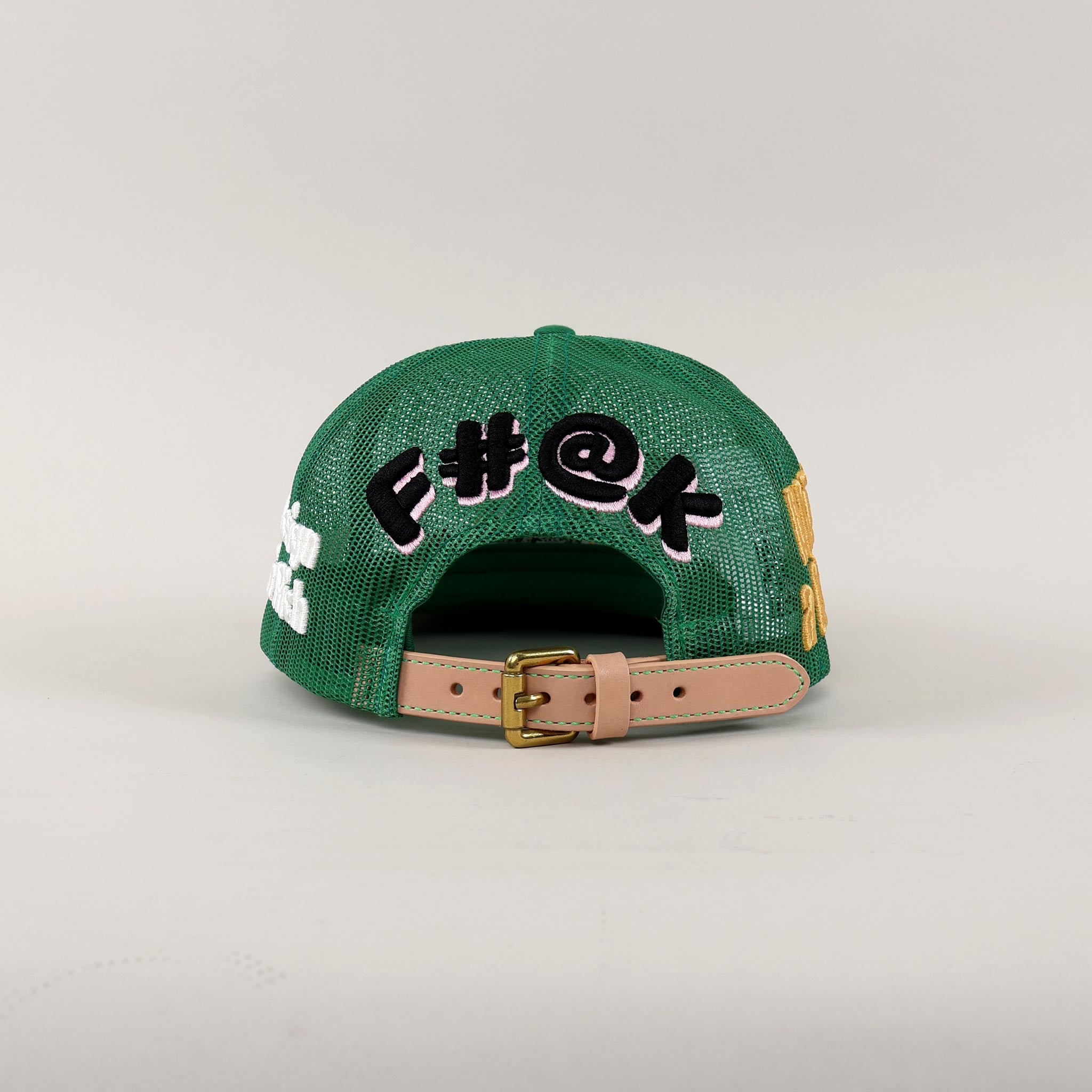 Black mesh cap with embroidered text and tan strap.