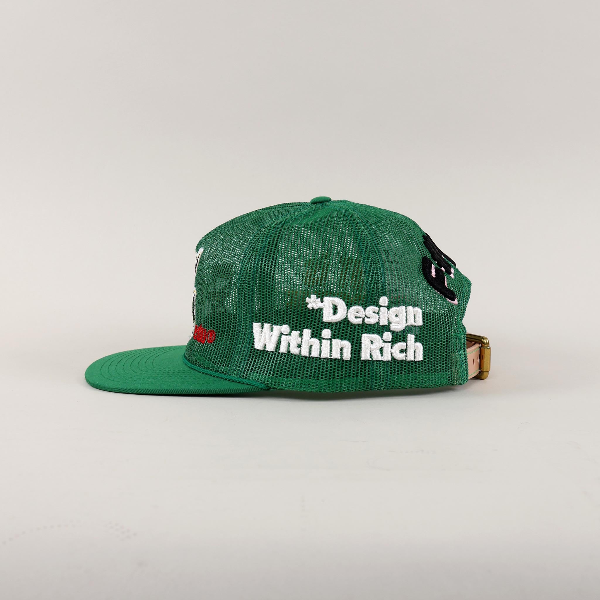 Black and white mesh cap with "Design Within Rich."