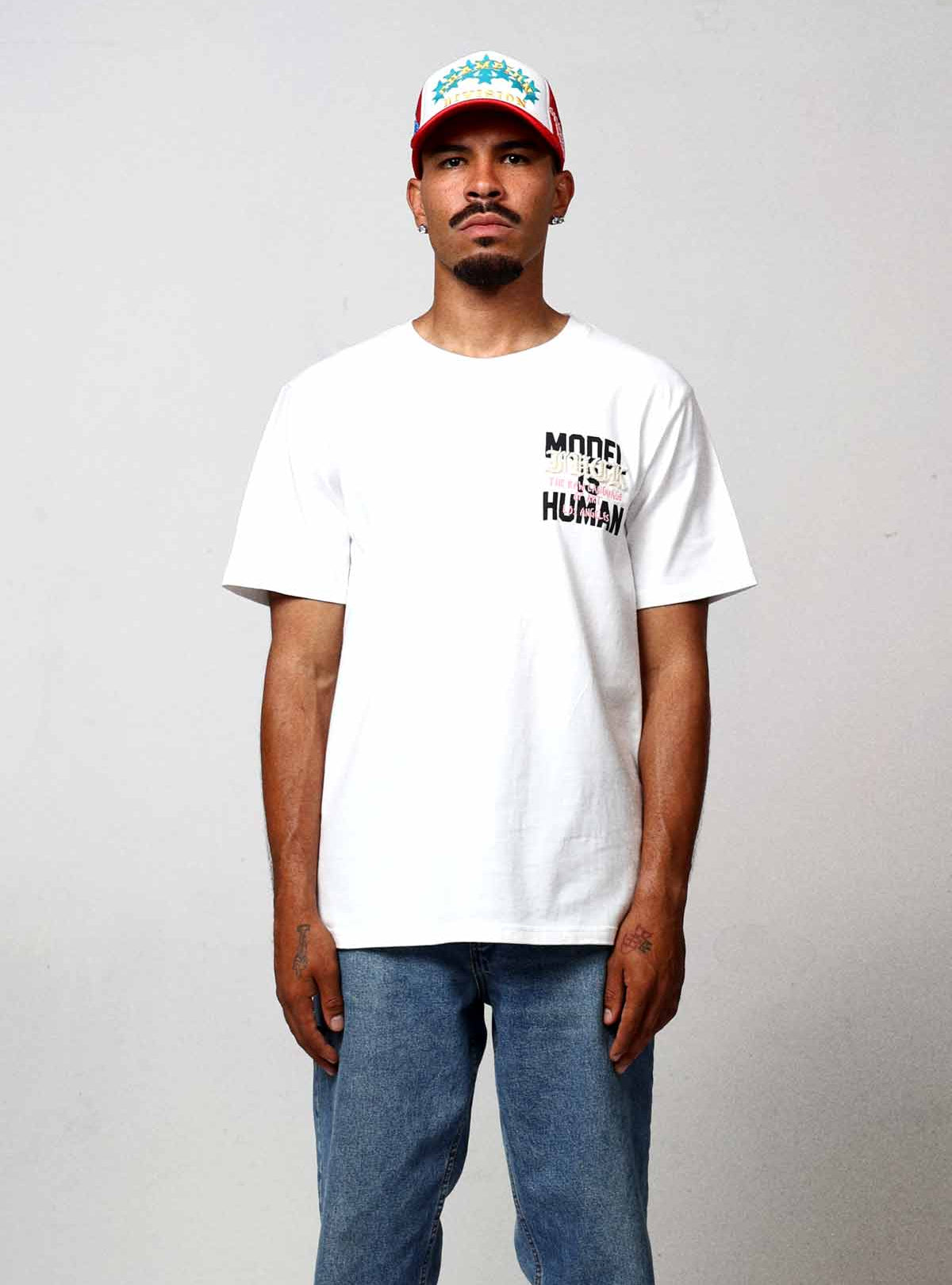 Man wearing white t-shirt and jeans.