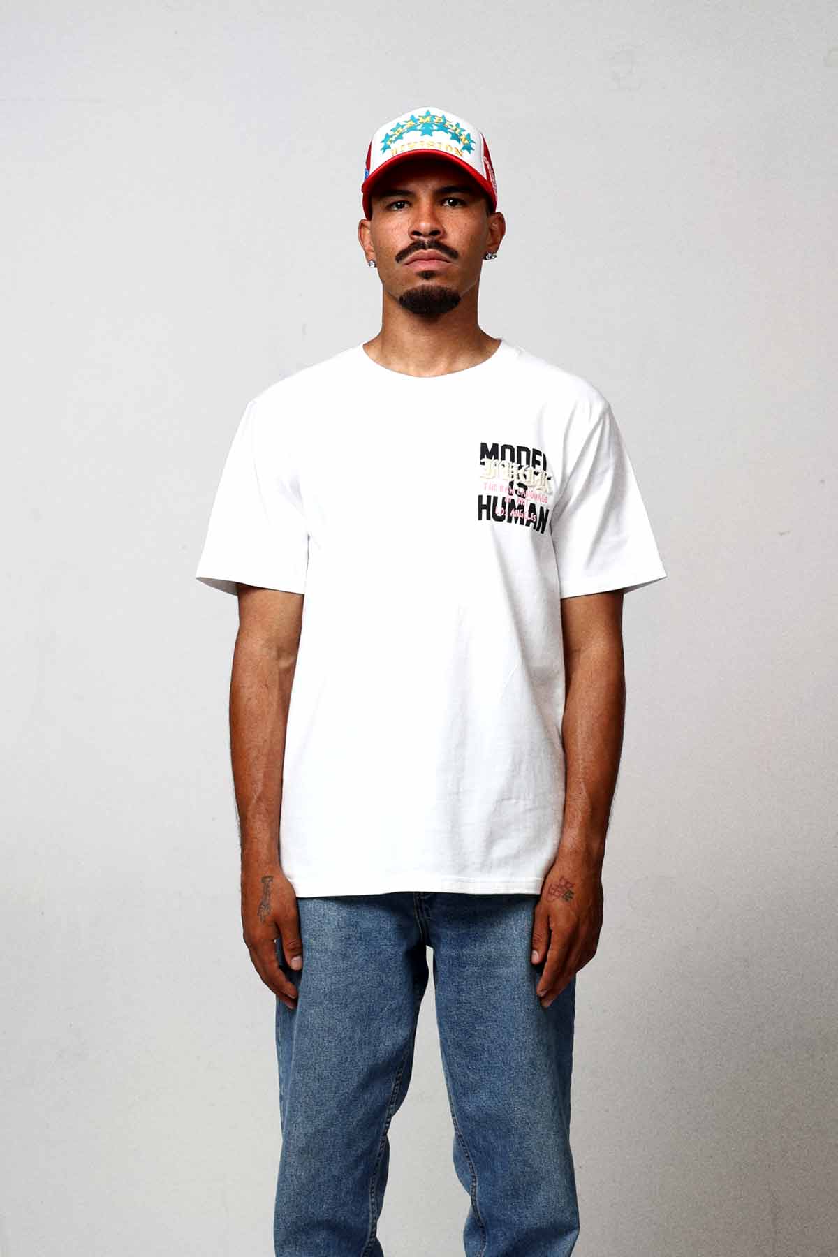 Man wearing white t-shirt and jeans.