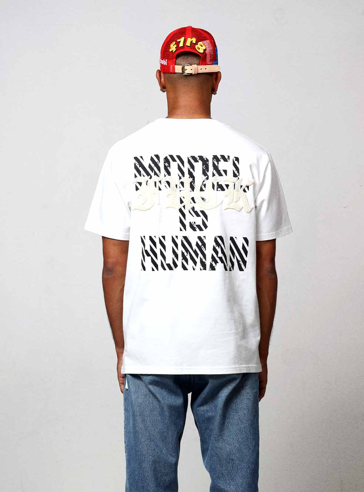 Man wearing a "Model Is Human" t-shirt.