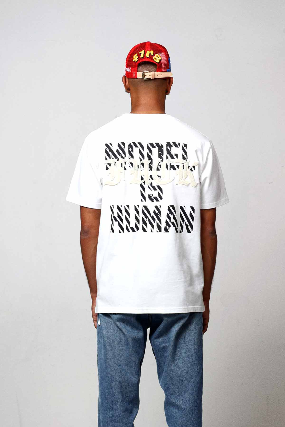 Man wearing a "Model Is Human" t-shirt.