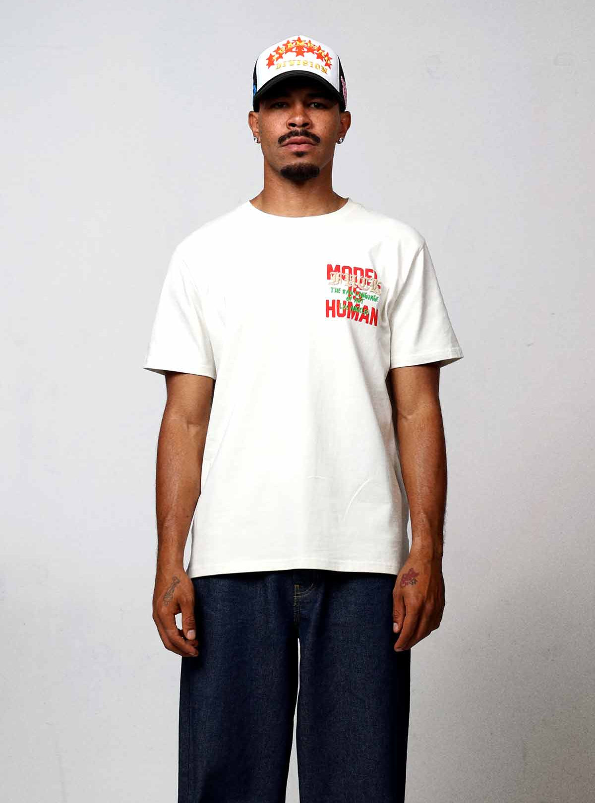 Man wearing white t-shirt and jeans.