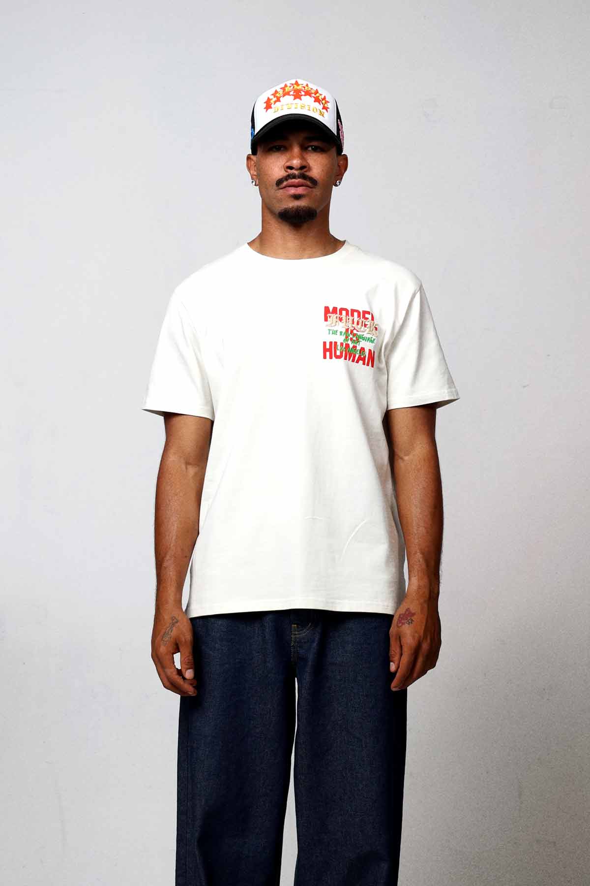 Man wearing white t-shirt and jeans.