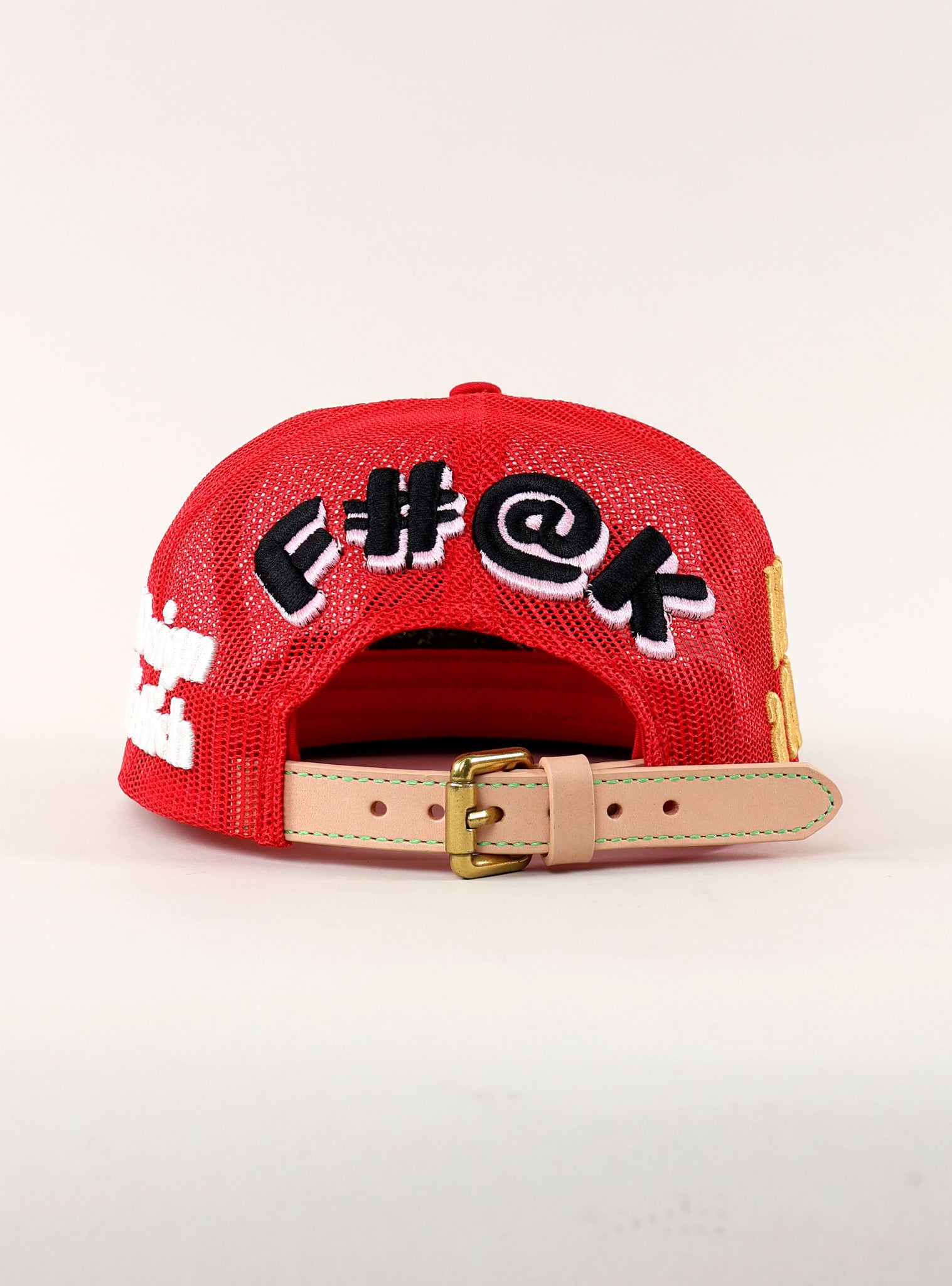 Red cap with bold text and adjustable strap.