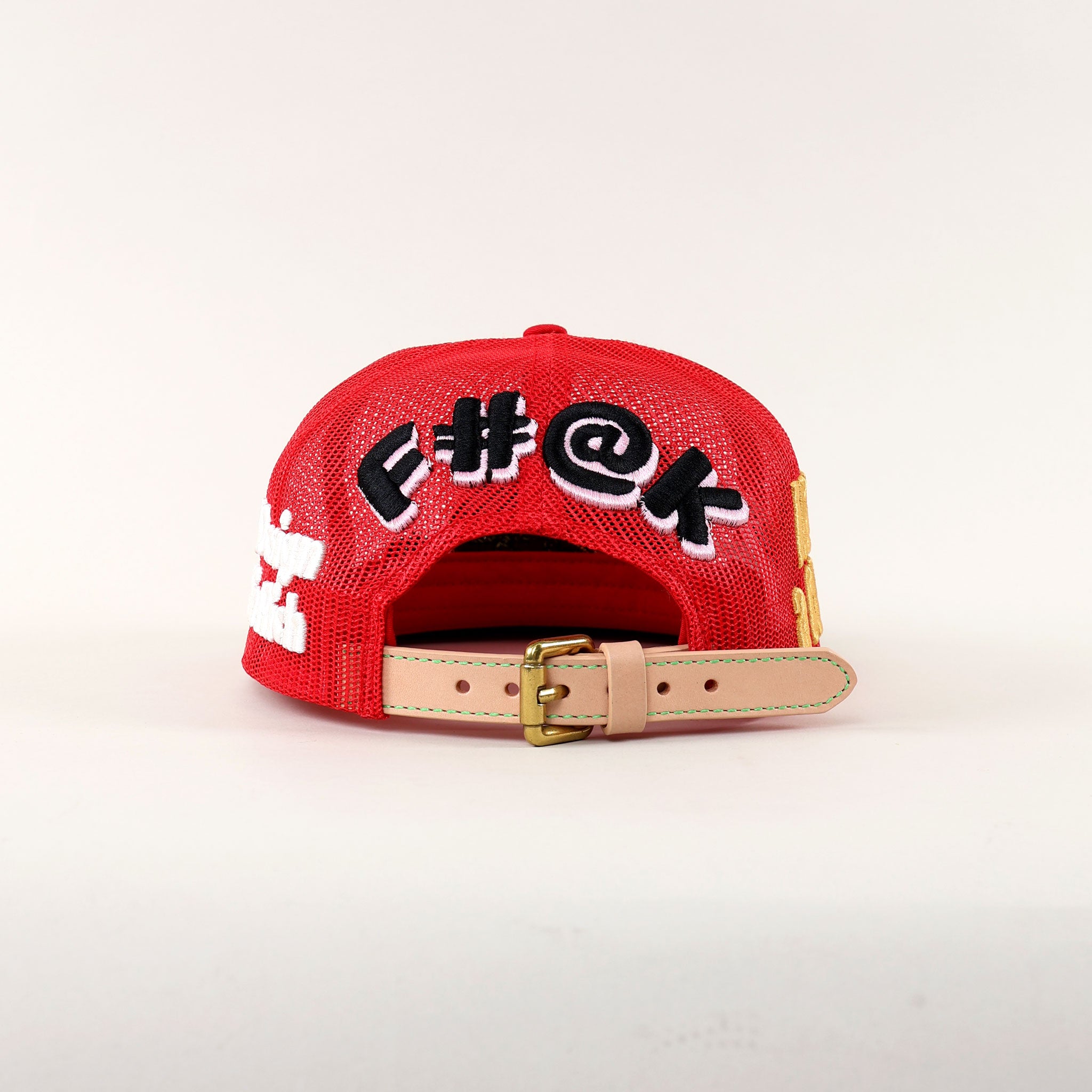 Red cap with bold text and adjustable strap.