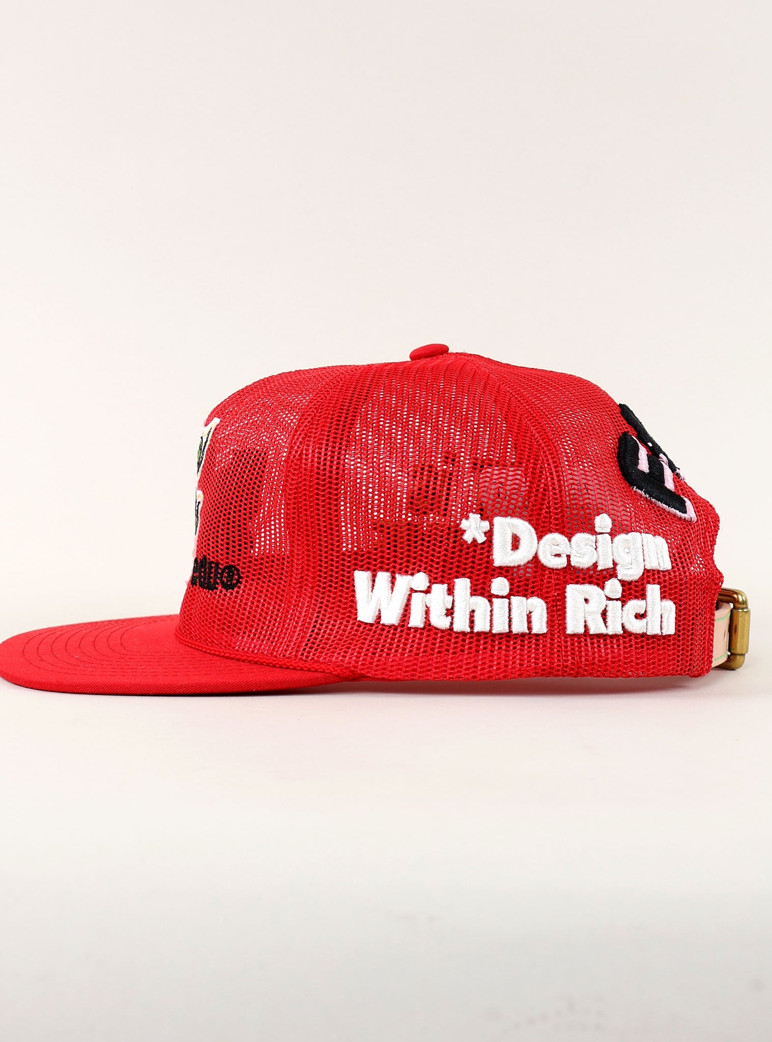 Red mesh cap with embroidered text.