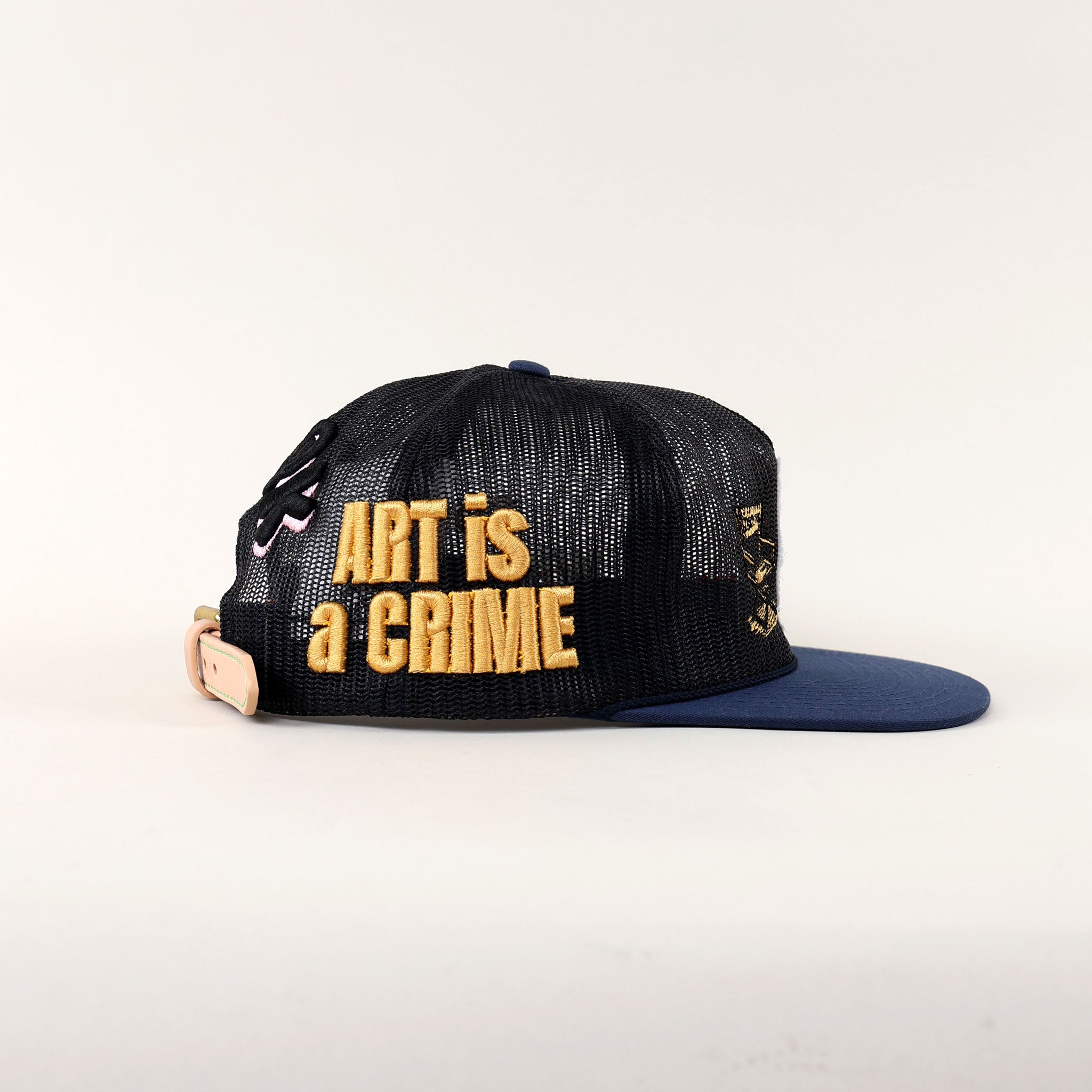 Black cap with "ART is a CRIME" text.