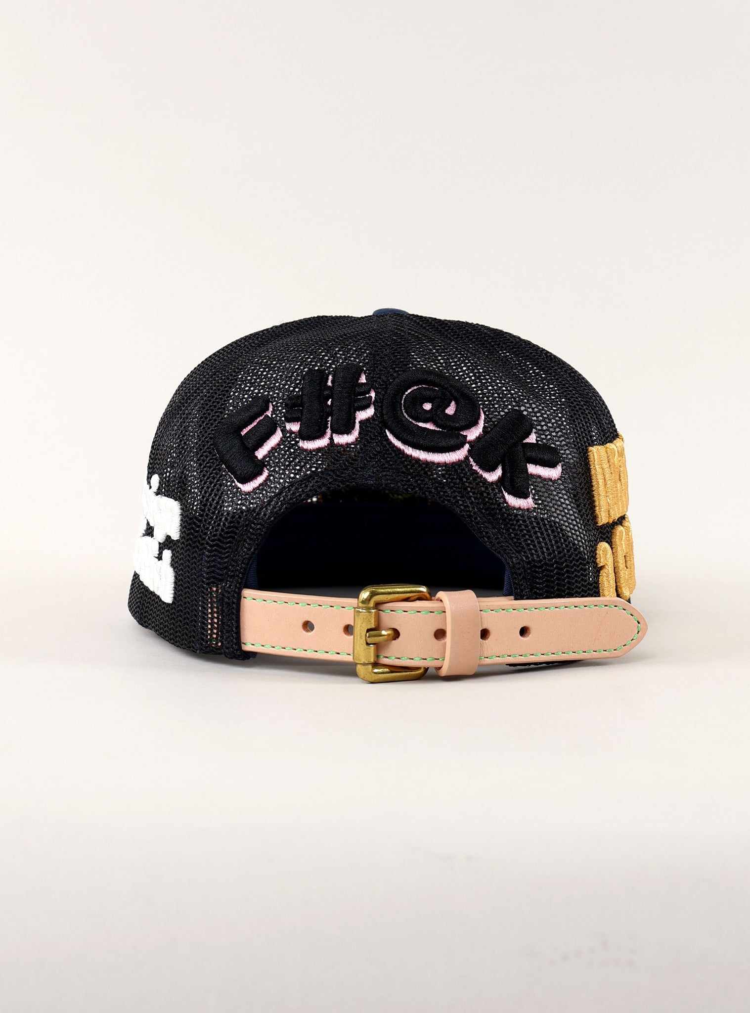 Back of a black cap with colorful embroidery.