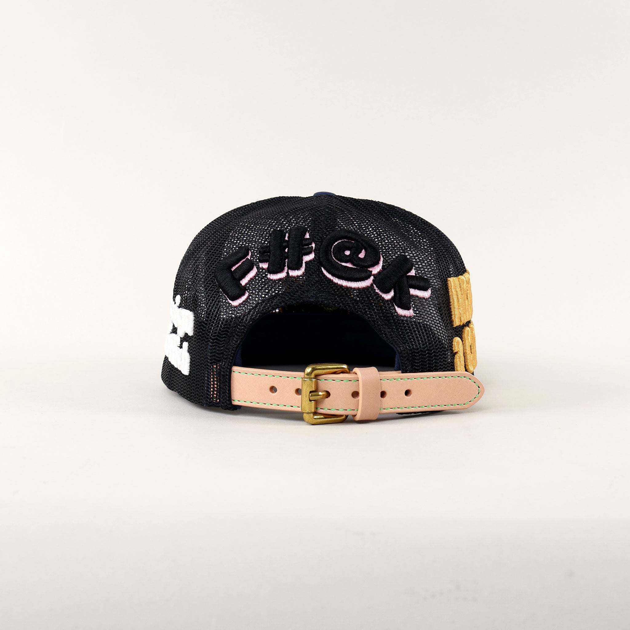 Back of a black cap with colorful embroidery.