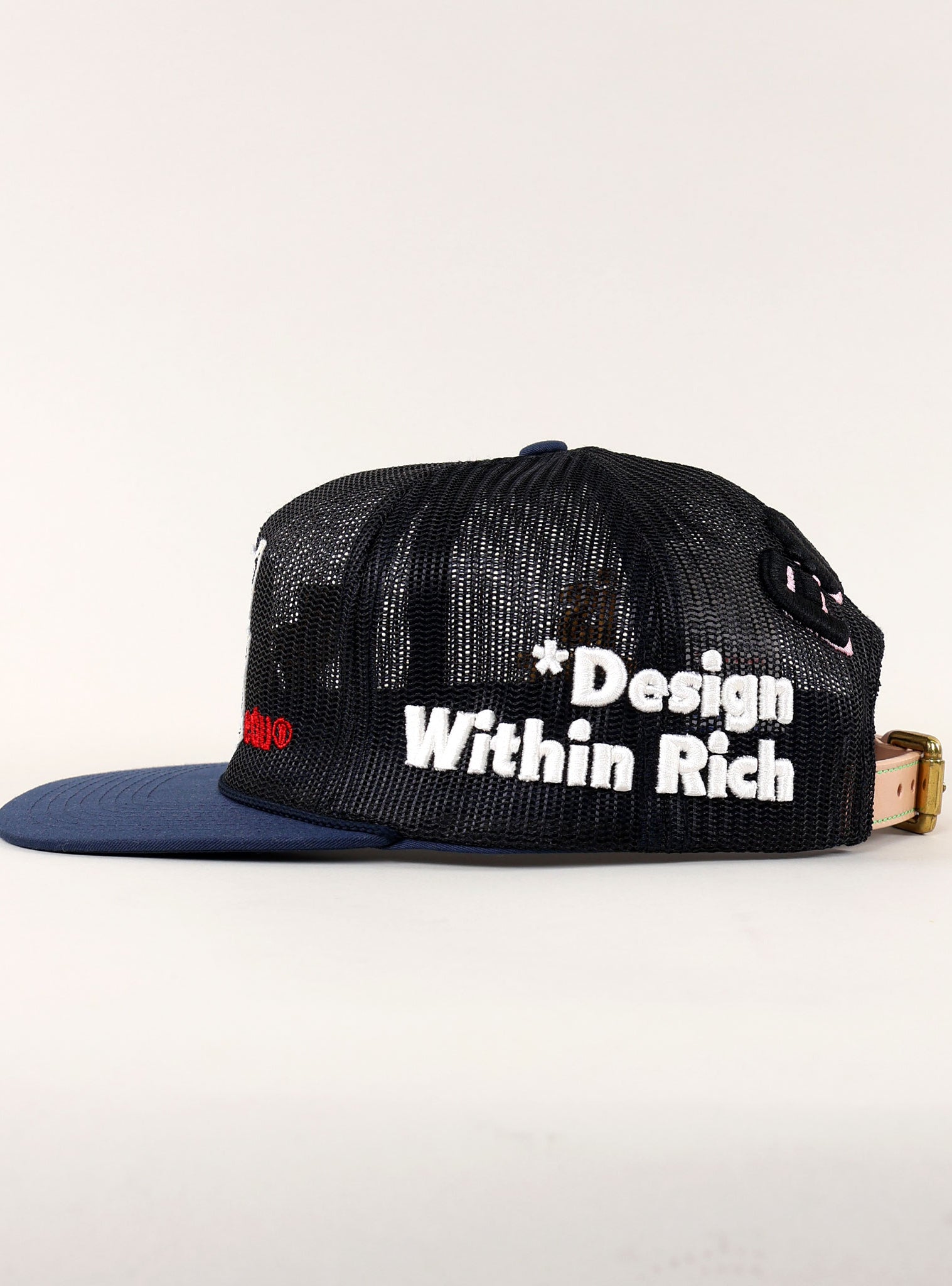 Black mesh cap with "Design Within Rich" text.