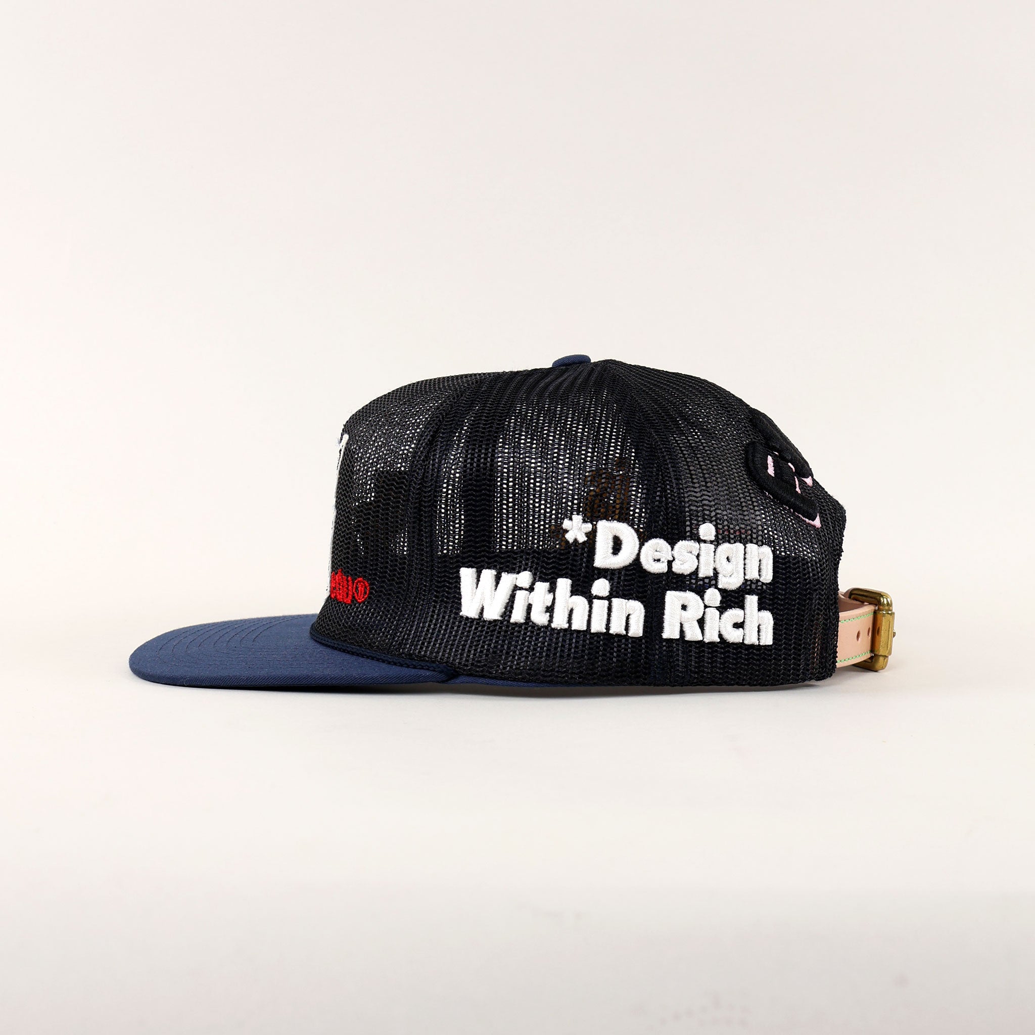 Black mesh cap with "Design Within Rich" text.