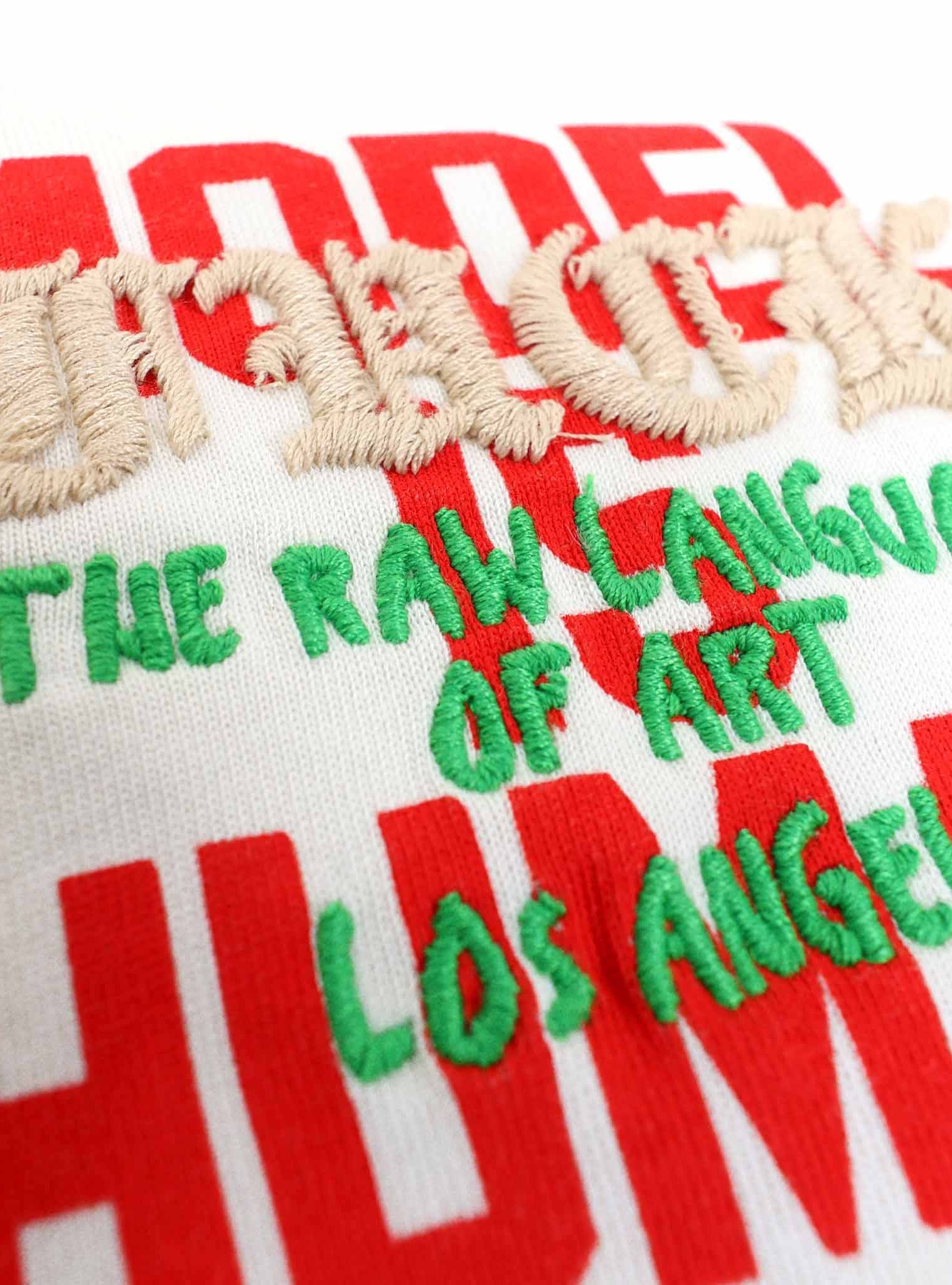 Embroidered text on fabric, colorful letters.