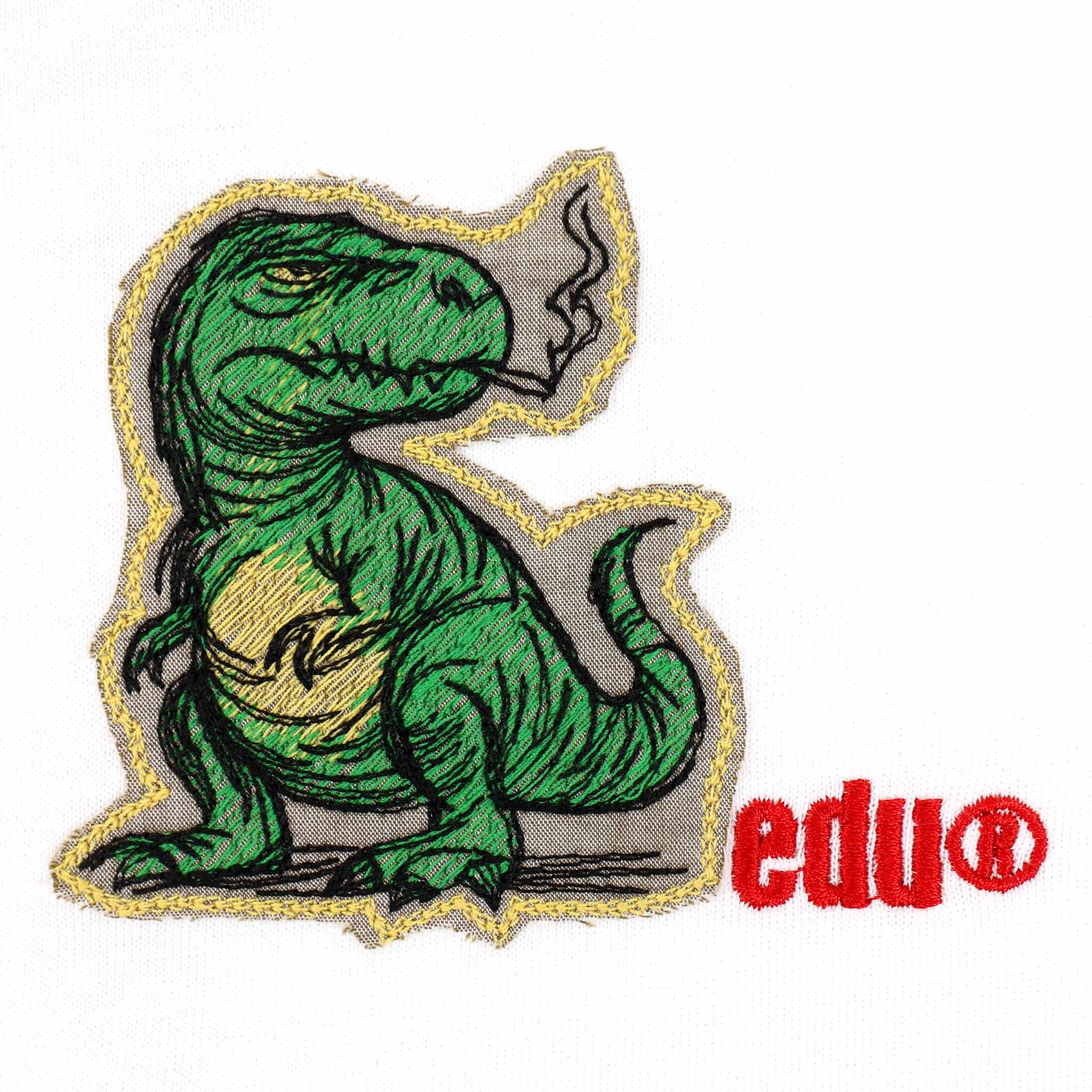 Green dinosaur smoking, embroidered on fabric.