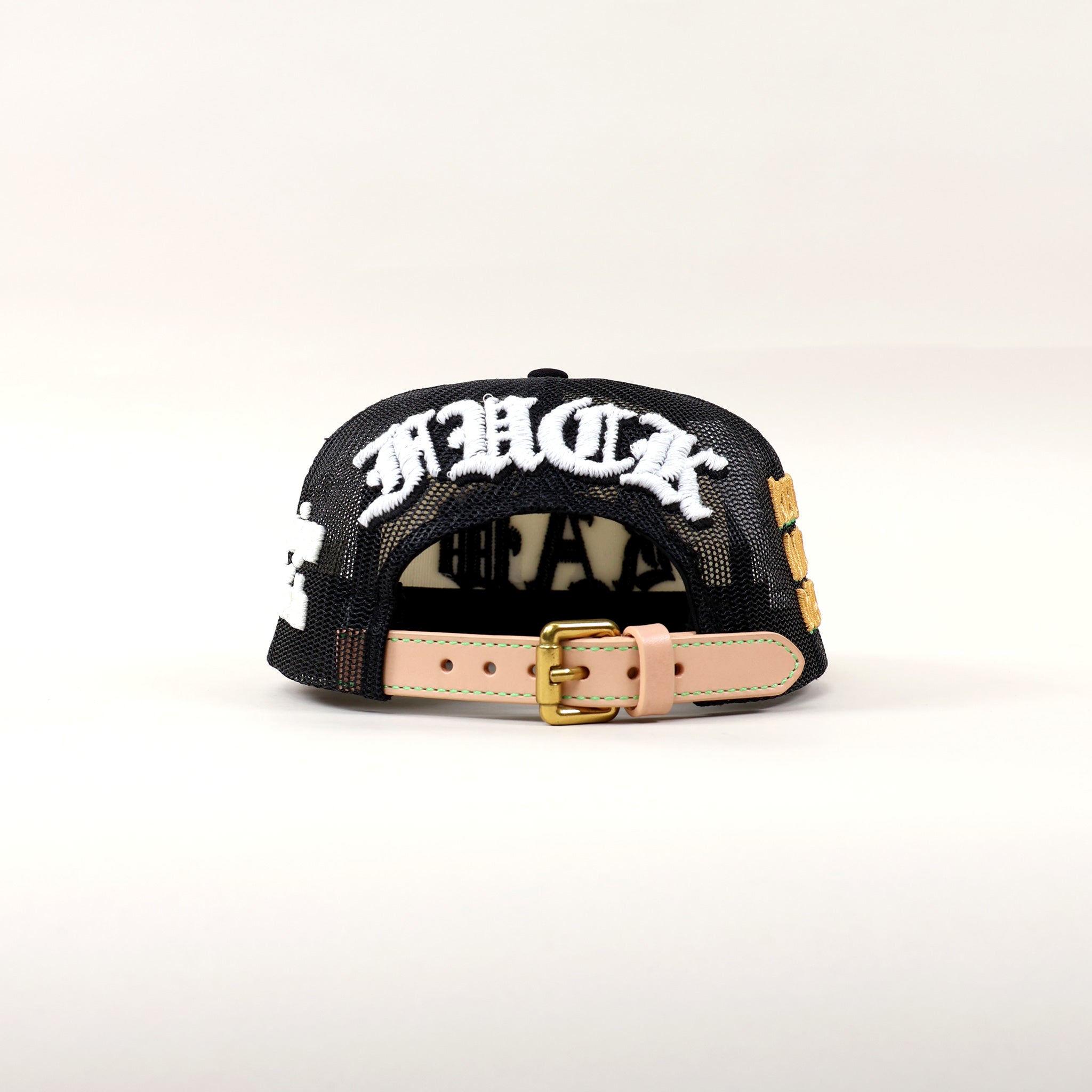 Black cap with white lettering and adjustable strap.