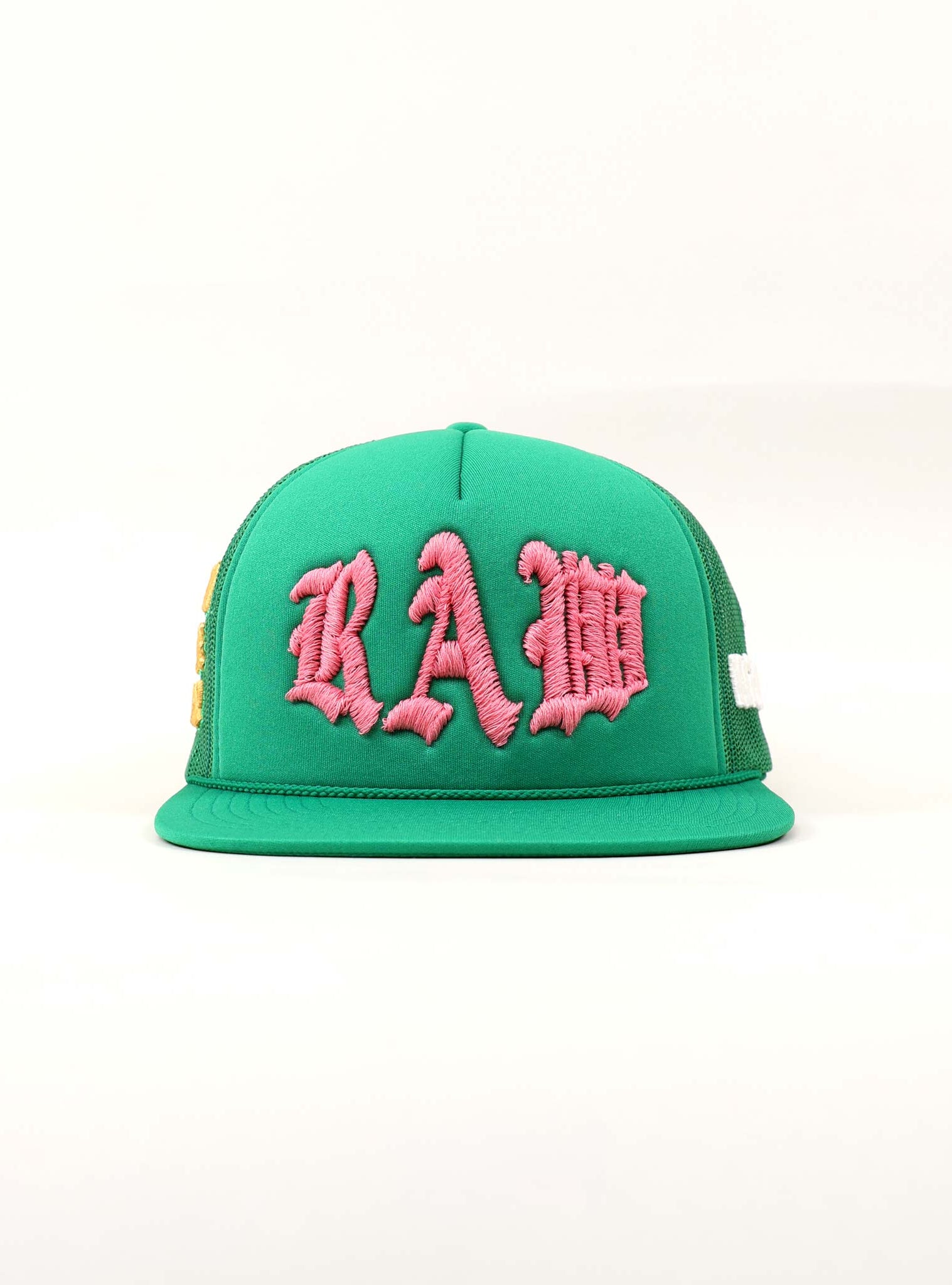 Green cap with pink "RAW" embroidery.